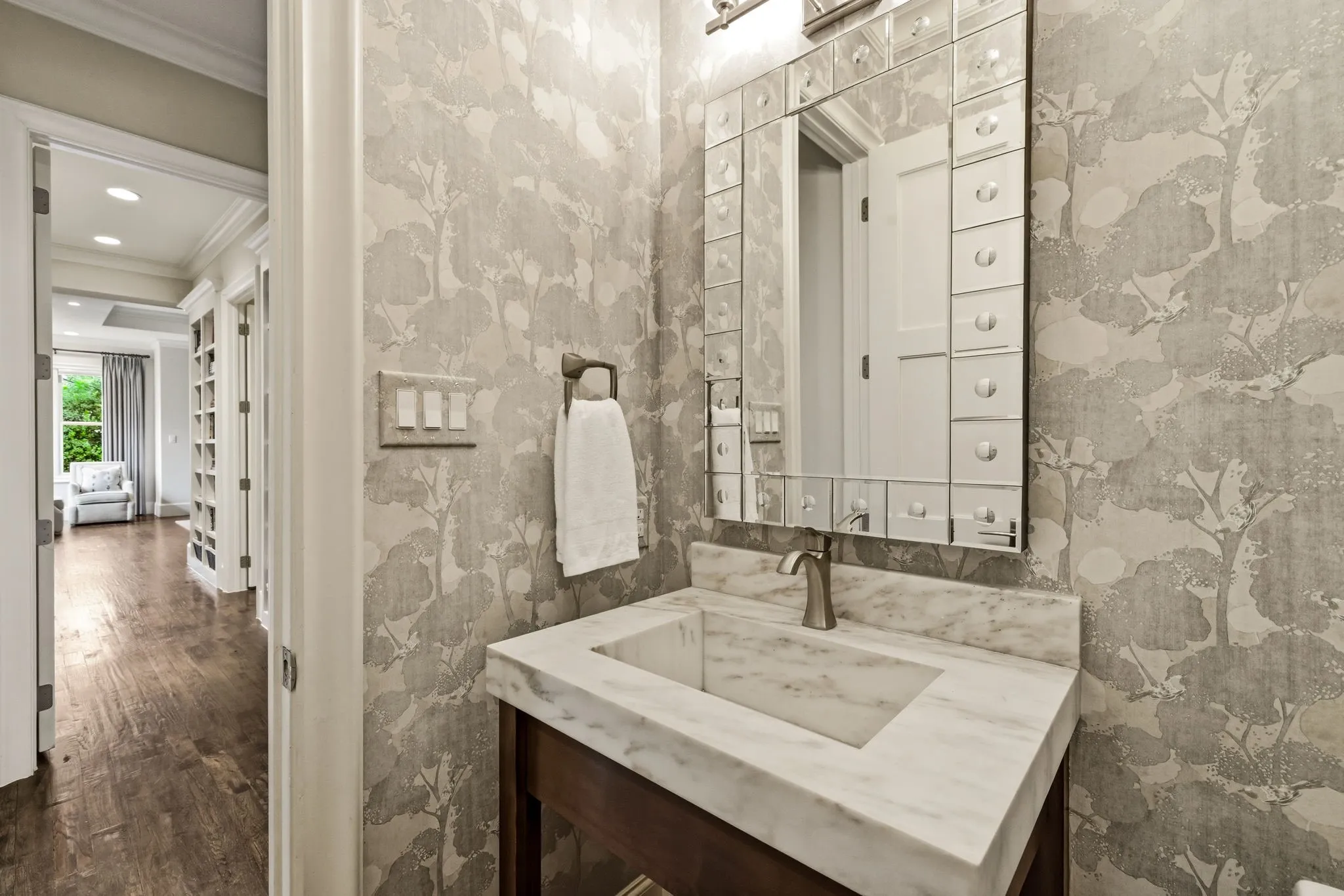 Guest bathroom on first floor with designer wall coverings.