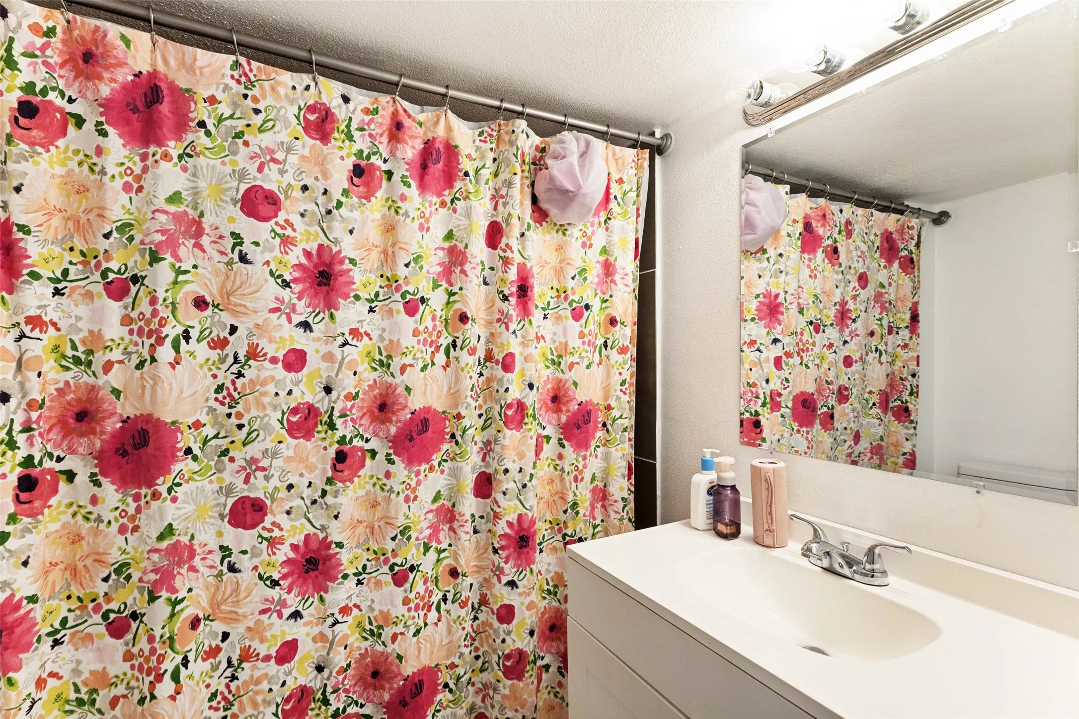 Built-in vanity with an integrated sink and chrome faucet, complete with a wall-mounted mirror