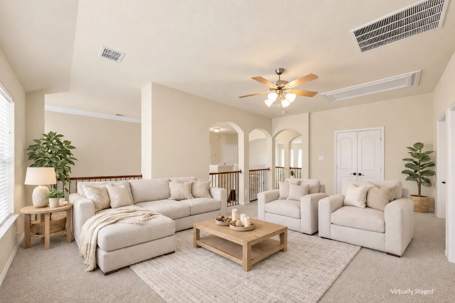 Arched doorways, vaulted ceiling, ceiling fan, and carpeted flooring