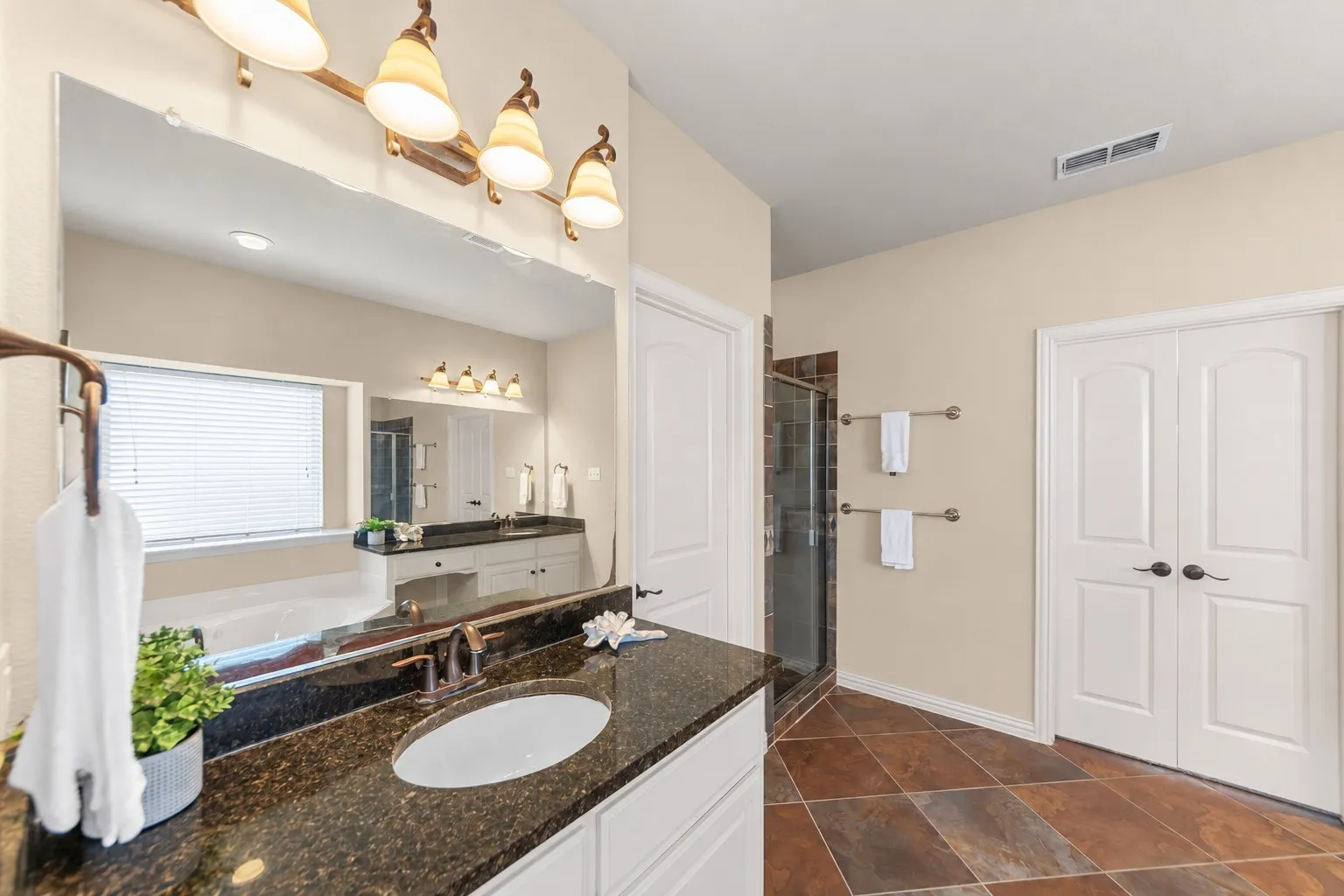Dual vanity with dark granite countertops and undermount sinks