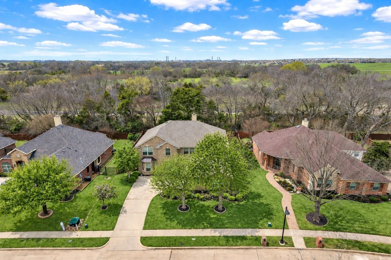 Brick exterior construction featuring an attached garage and front-facing entryway