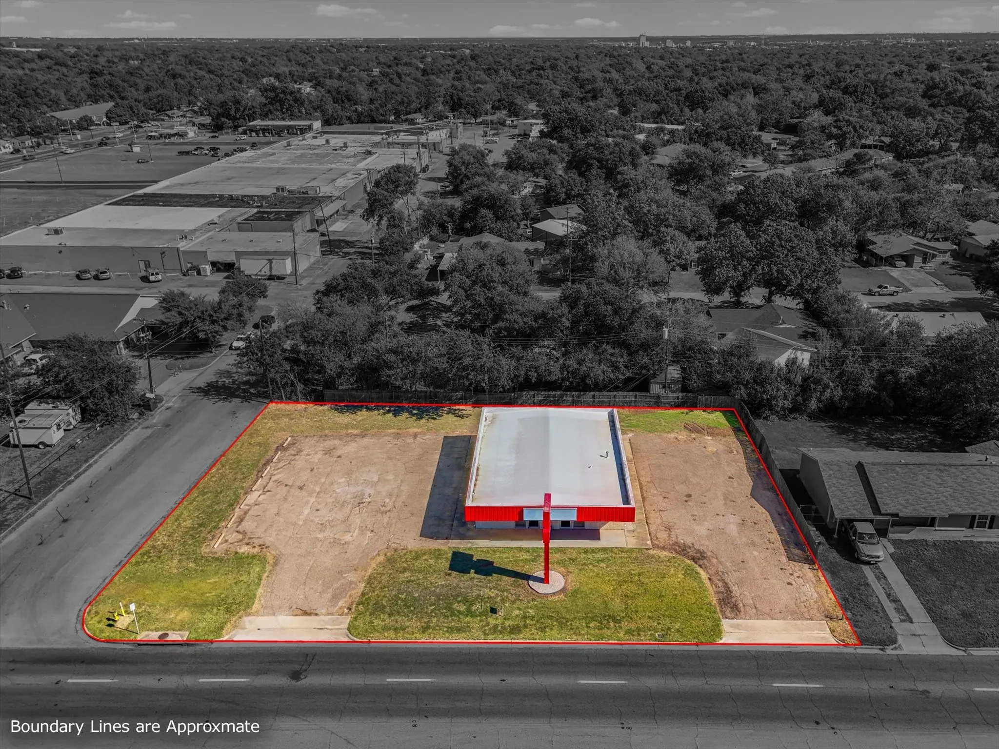 Aerial view showing both parking lots and frontage on New Road.
