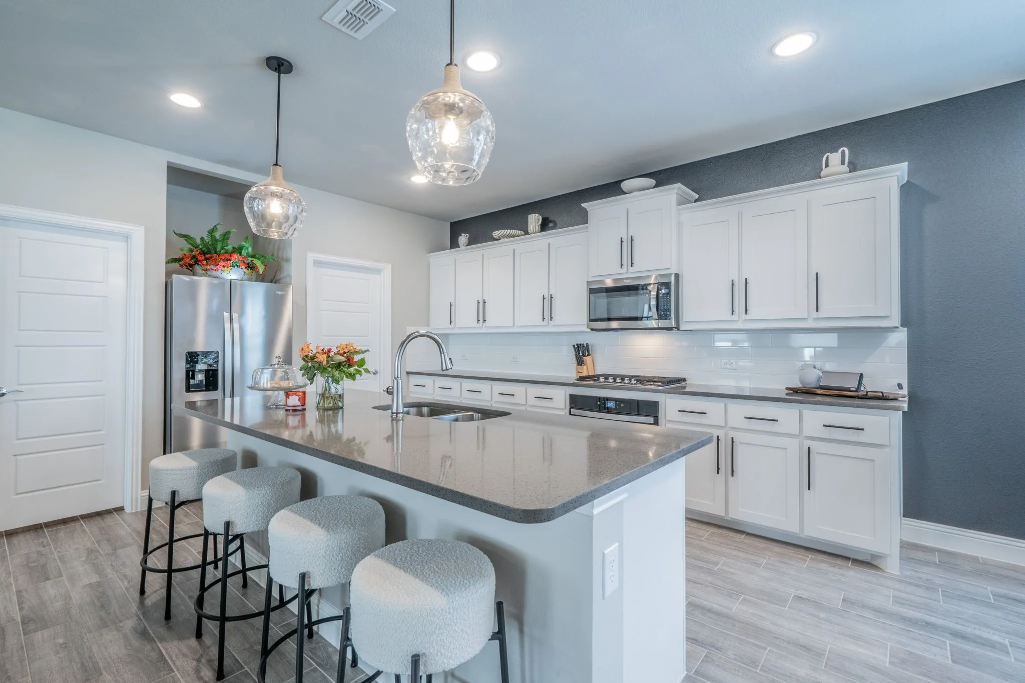Beautiful kitchen with oversized island and decorative lighting.