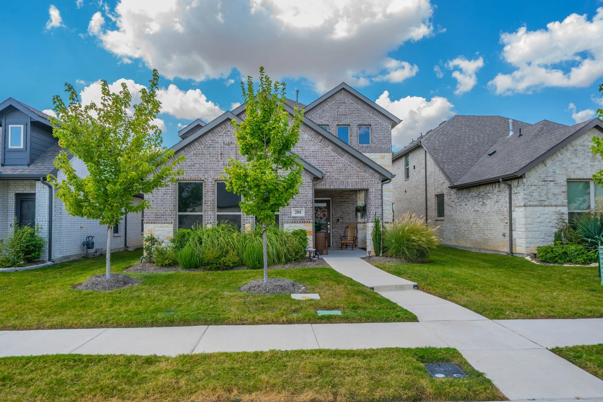 Beautiful brick and stone home with covered porch-such curb appeal!