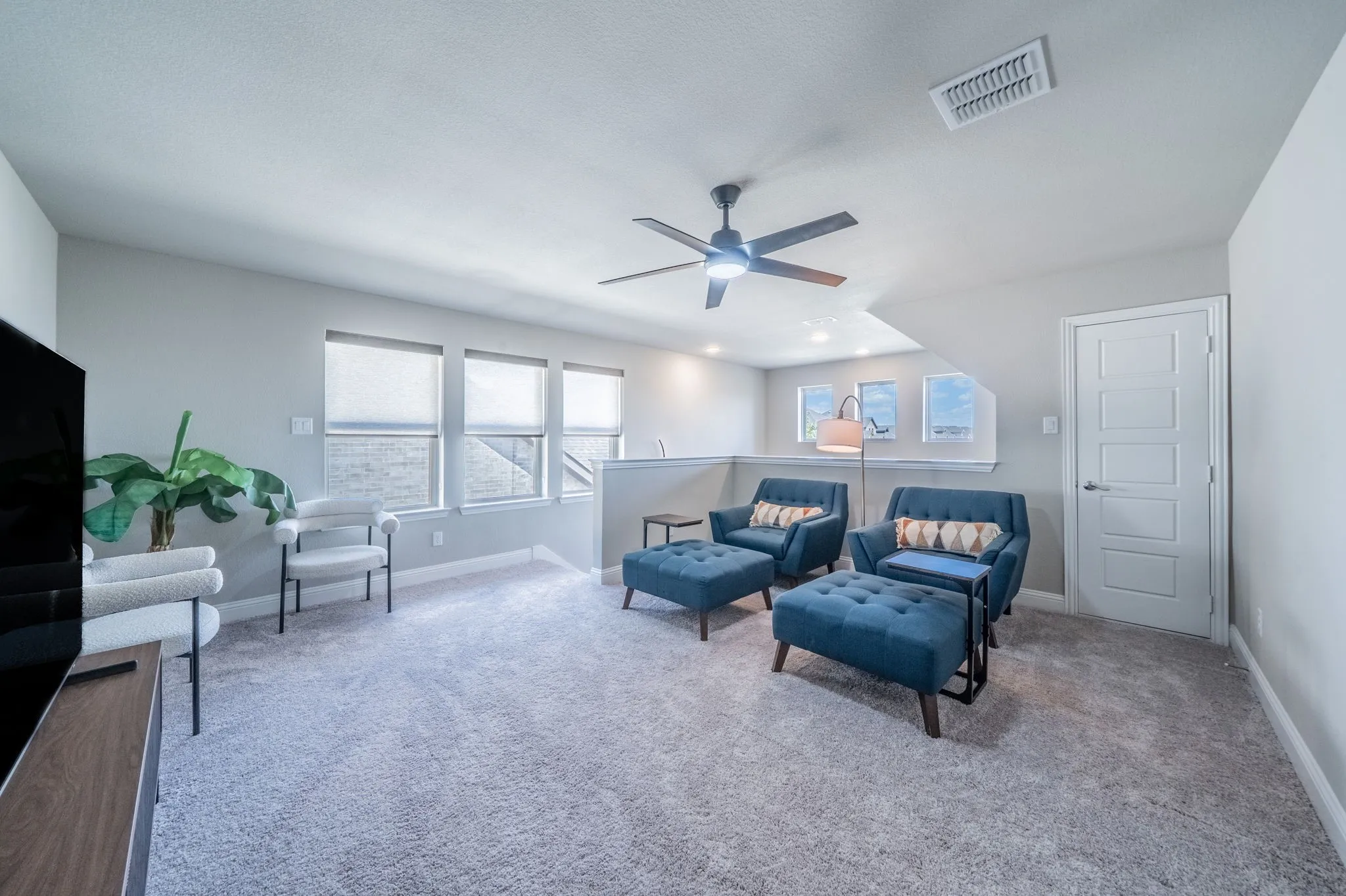 This is the upstairs bonus room or game room. Tons of natural light and space to entertain!