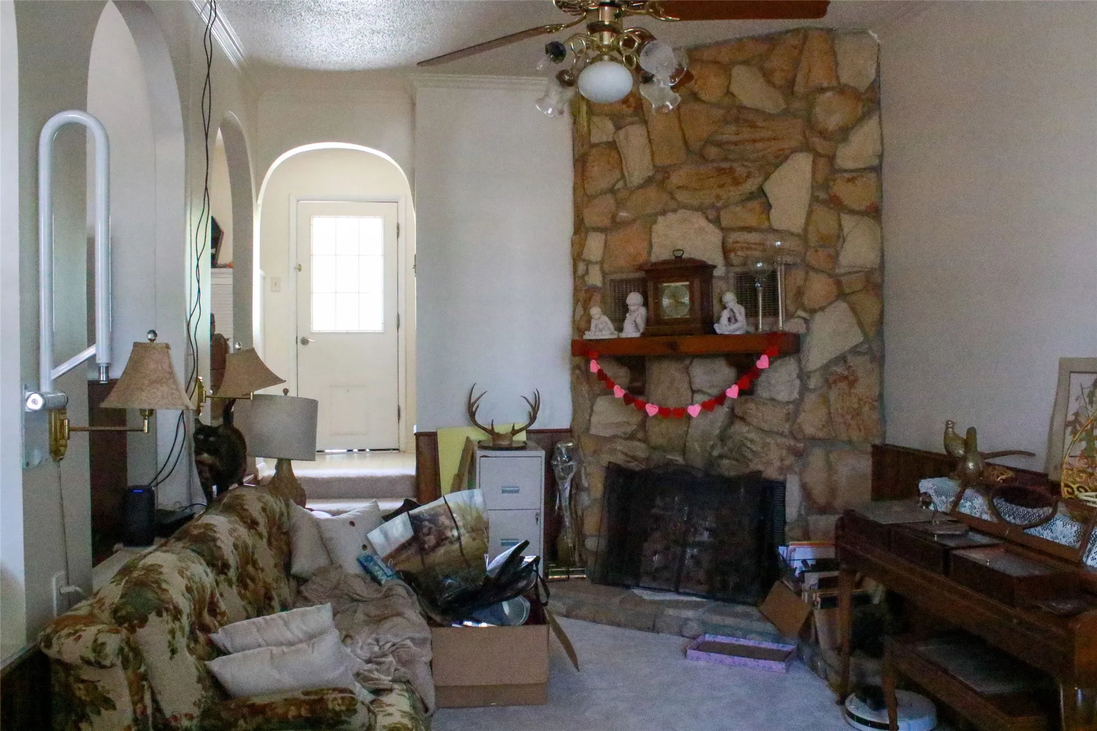 Stone-clad fireplace with a wood mantel