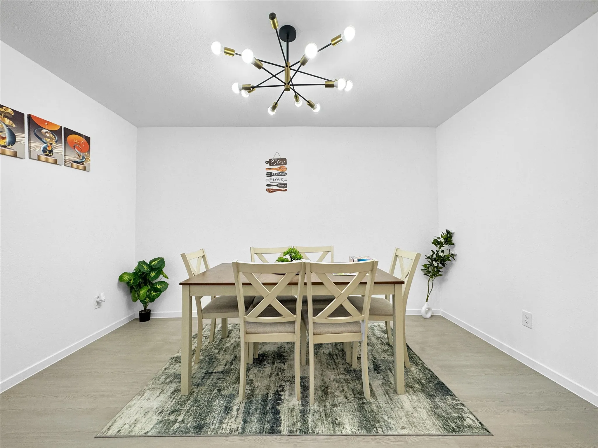 Recessed lighting, wood-finish flooring, and a modern ceiling fixture create an inviting atmosphere