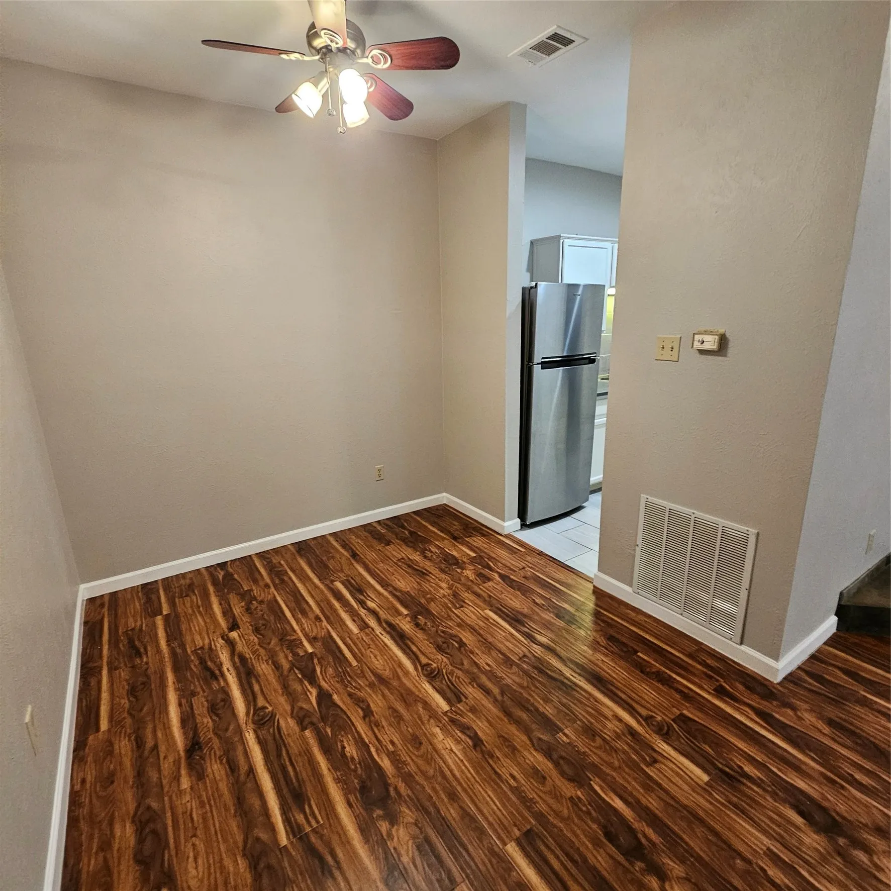 Spare room featuring light wood finished floors and a ceiling fan