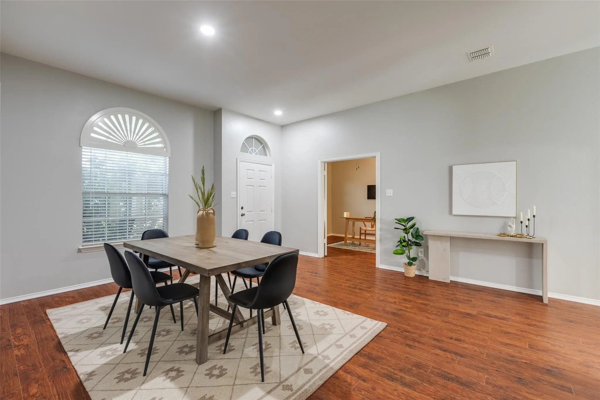 Spacious room with wood-finish flooring, recessed lighting, and light gray walls