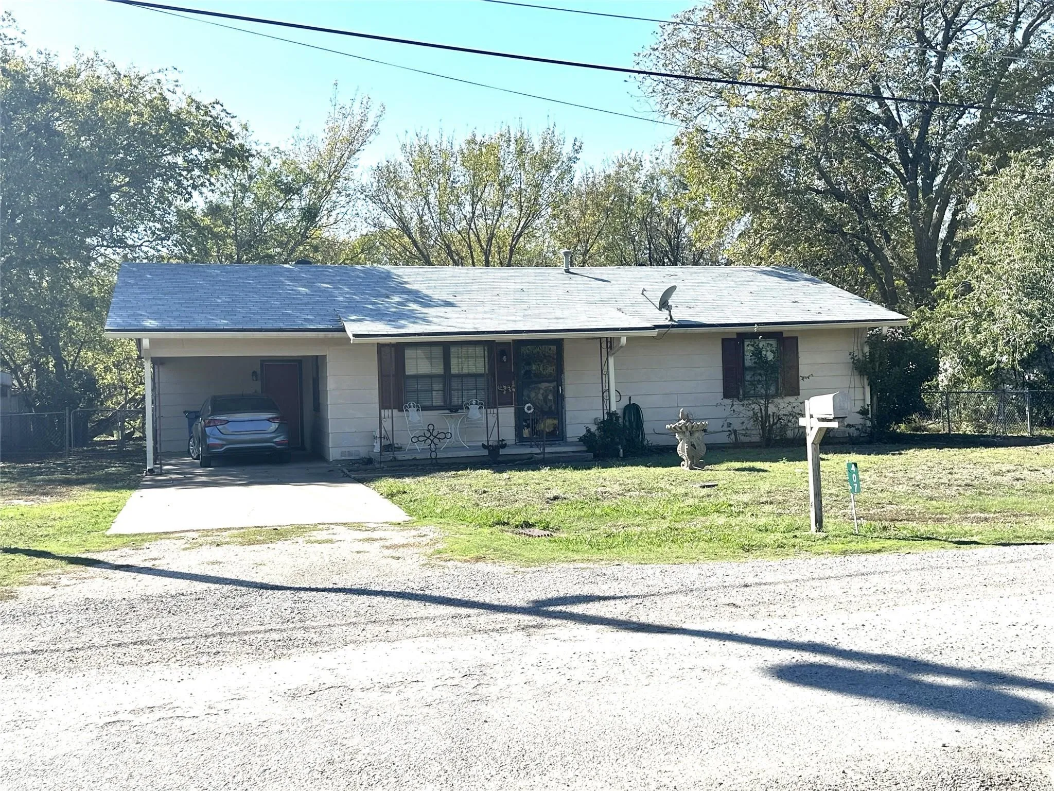Single-story residence with a covered carport, concrete driveway, and front-facing entryway