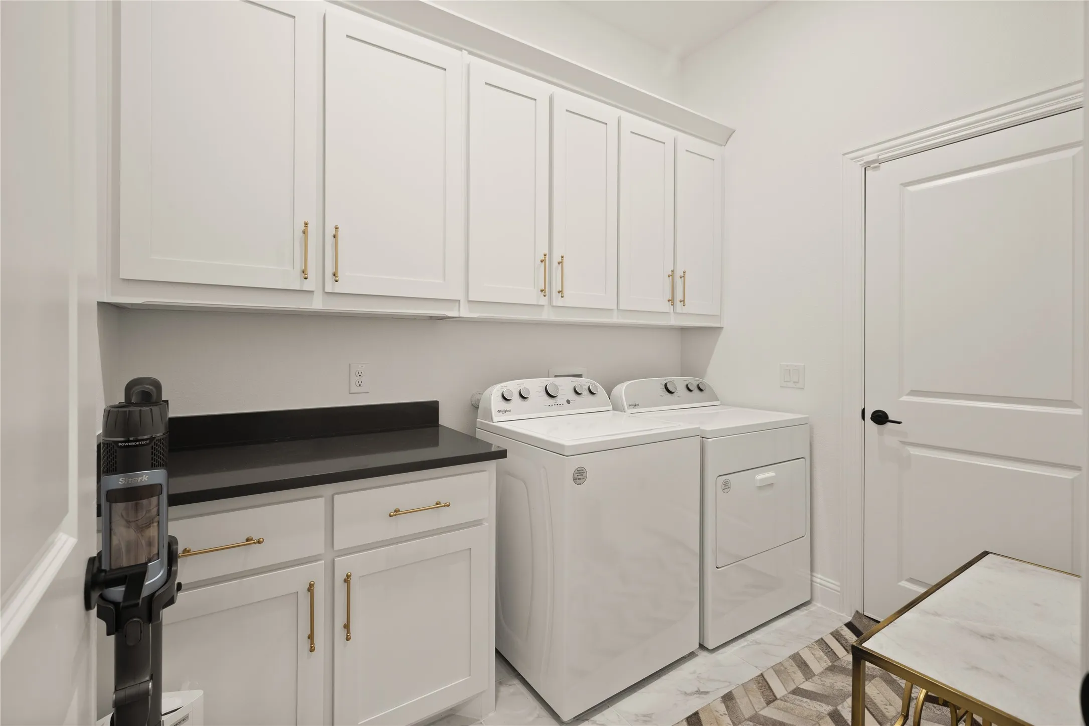 Laundry room with granite counters for folding spaces, numerous cabinets for additional storage and your designated door to your third garage.