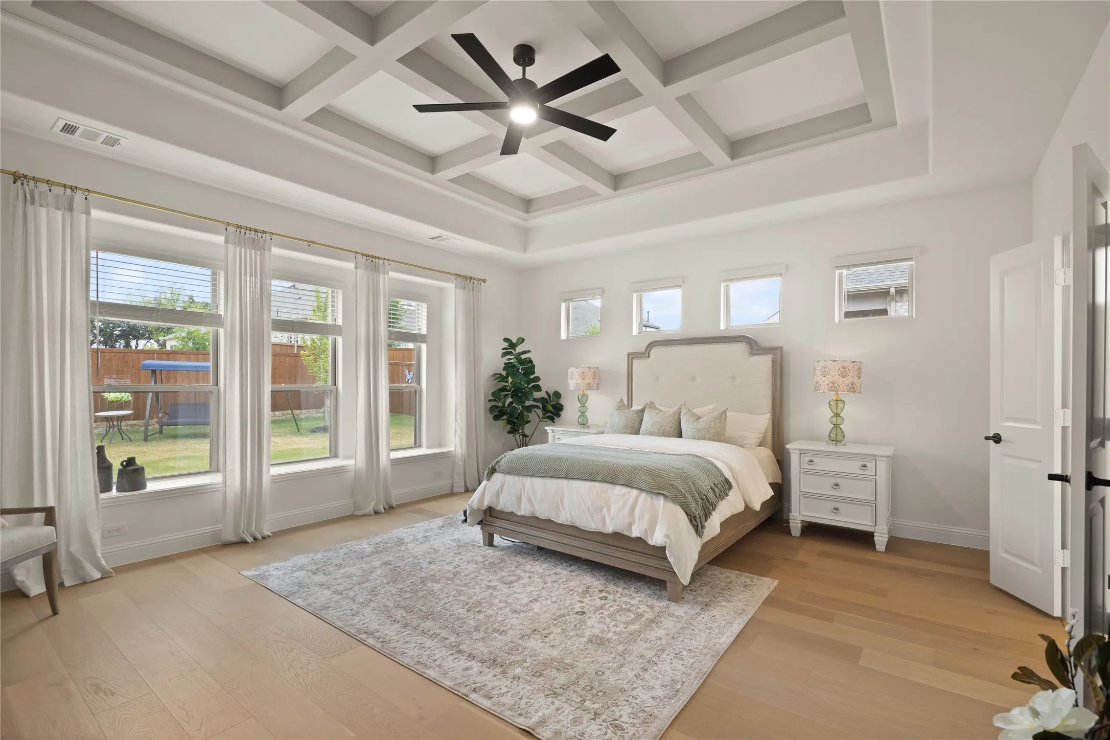 This master space was designed with luxury in mind. Expansive, design, multiple windows for natural light, tray ceilings, and the view!