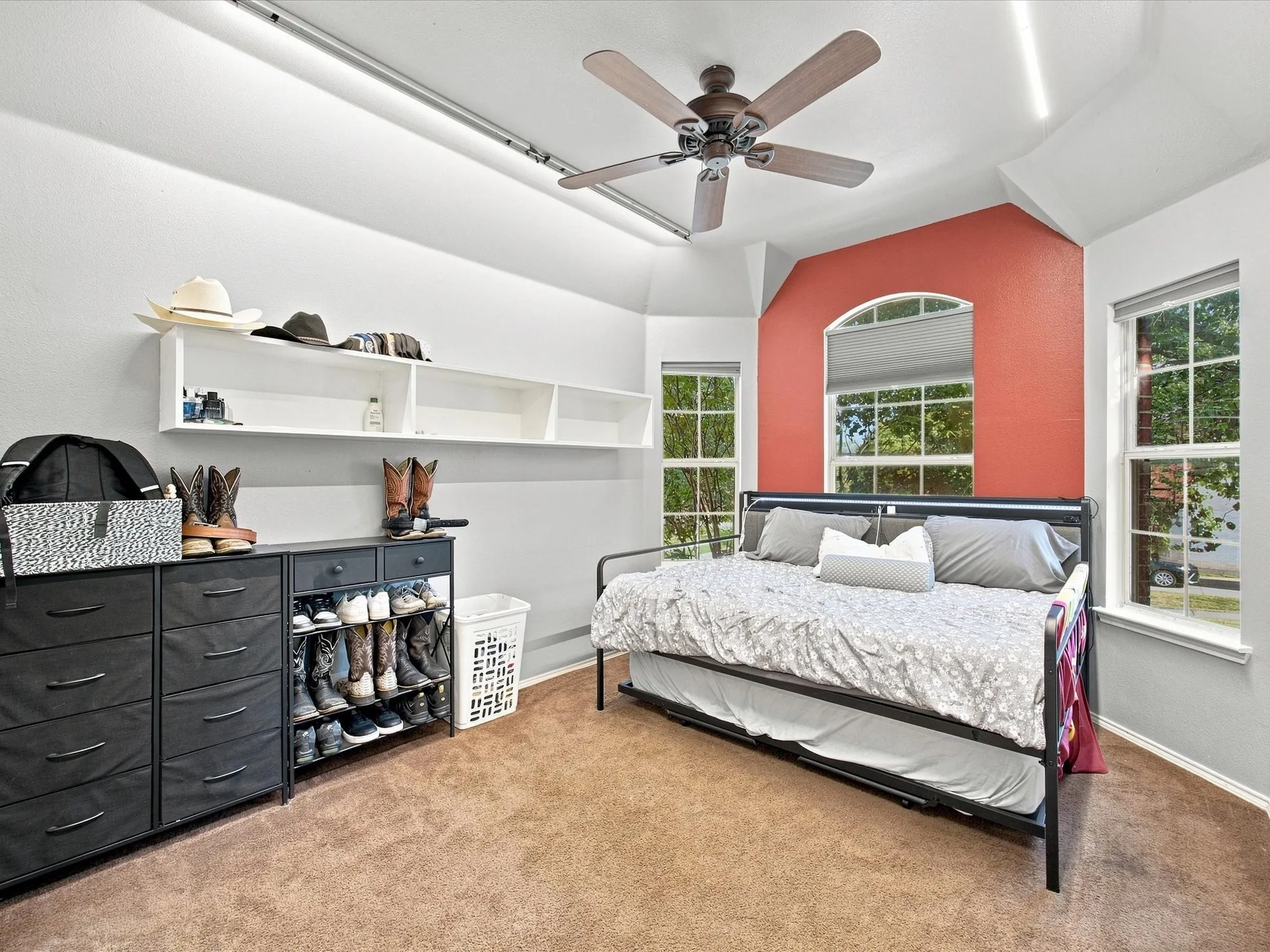 Vaulted ceiling with an installed ceiling fan and track lighting