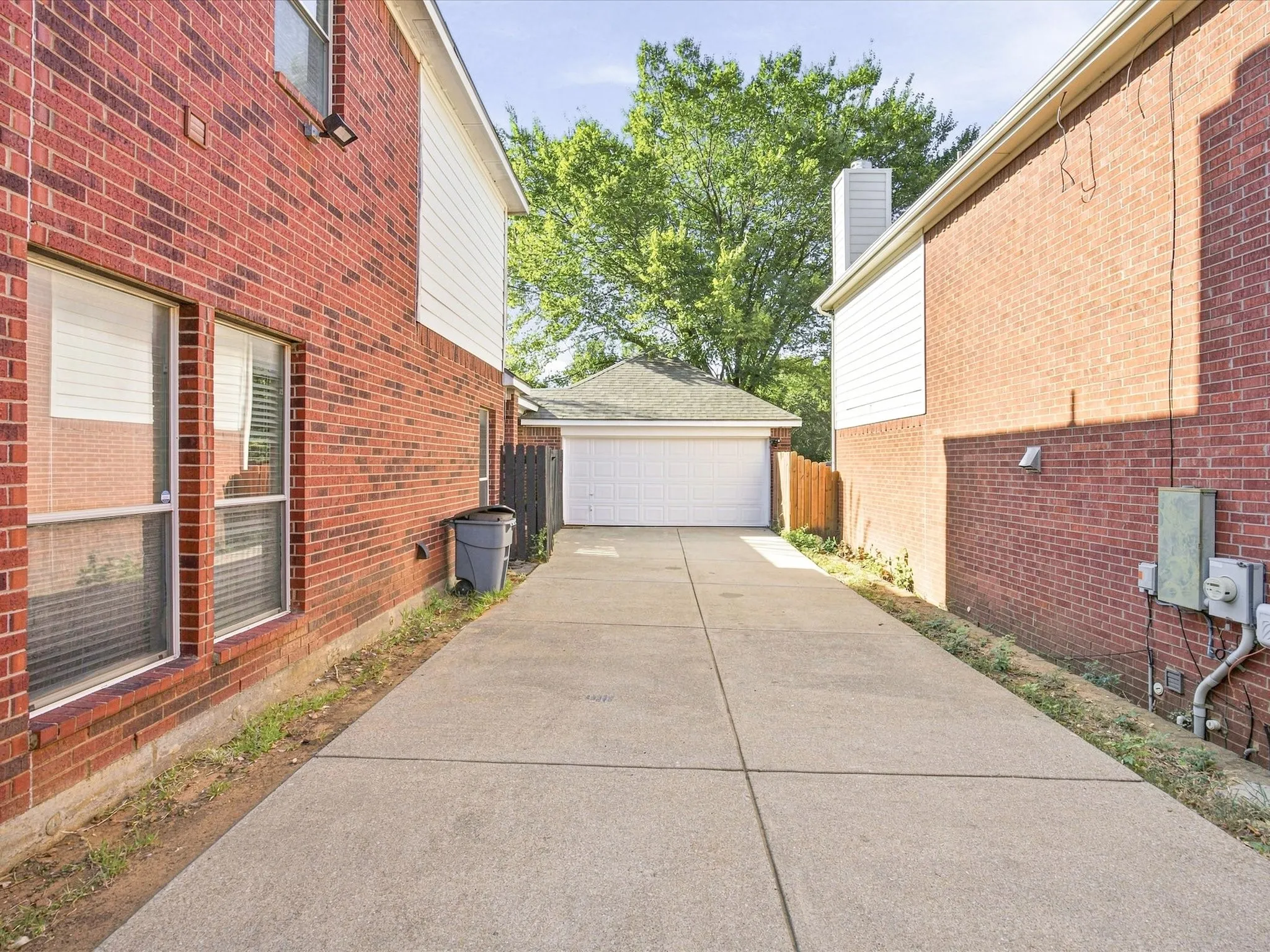 Concrete driveway leading to a detached garage