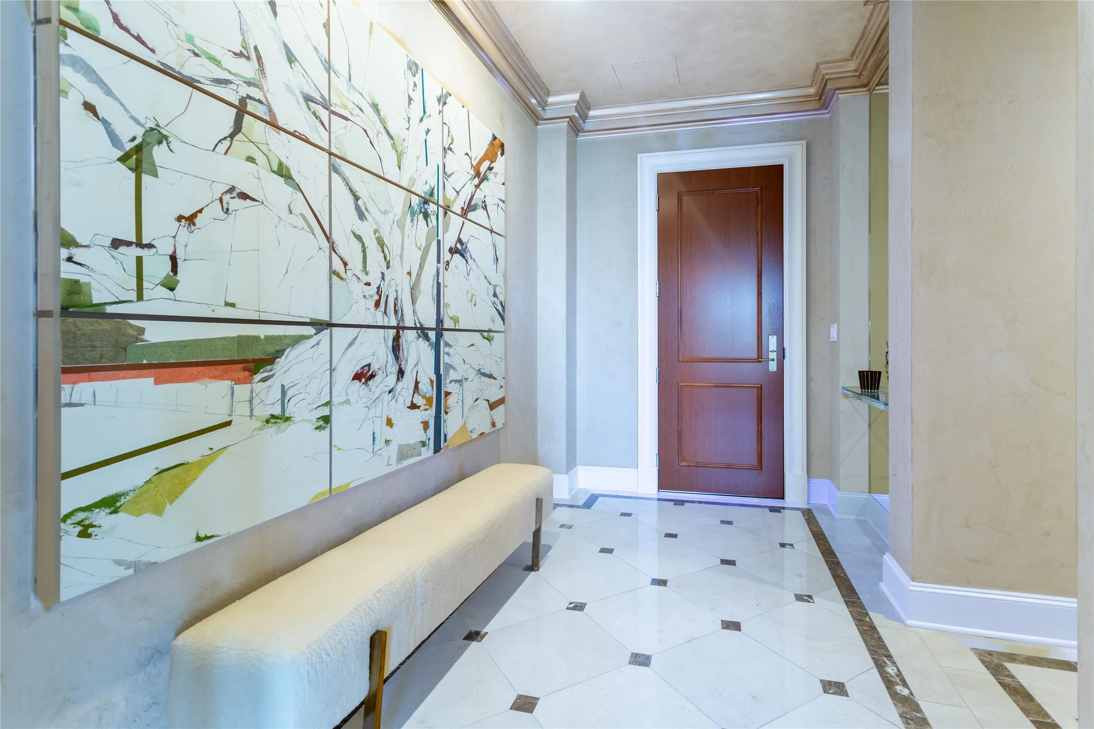 Inlaid Marble & Venetian Plaster entry with dramatic art wall.