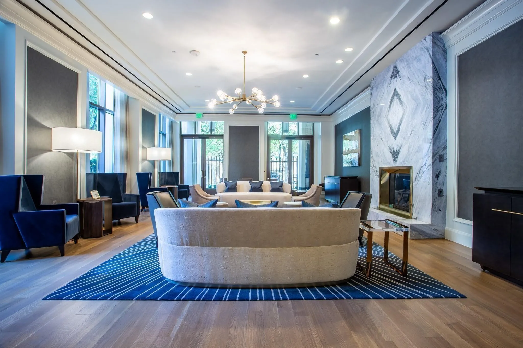 Large Owner's Lounge with book-matched marble FP, perfect for gatherings or happy hours.