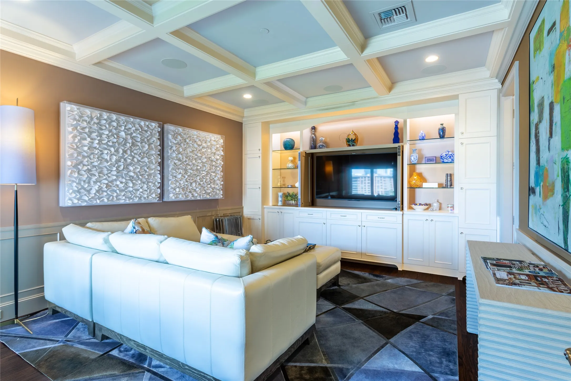 Wall of built-ins with doors to hide the TV