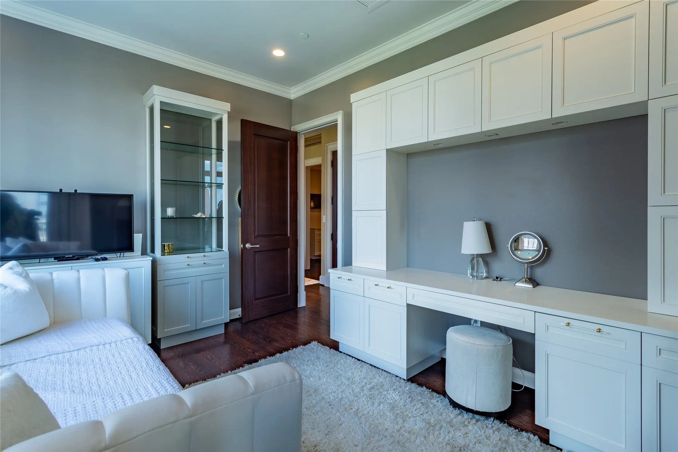 Study has a wall of built-ins and a pop-up TV.
