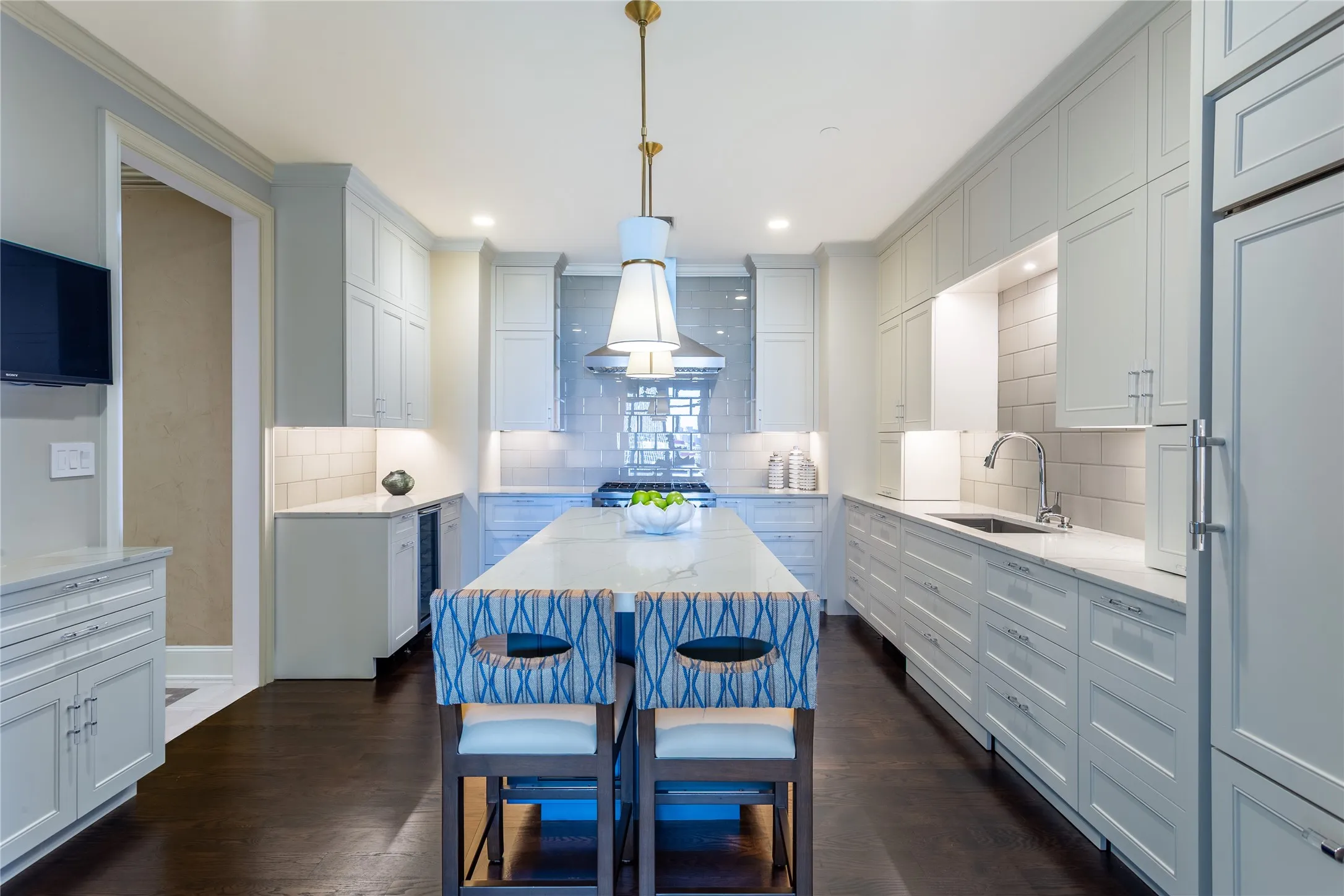 Renovated Kitchen has custom cabinets, Quartz counters and glass tile backsplash.