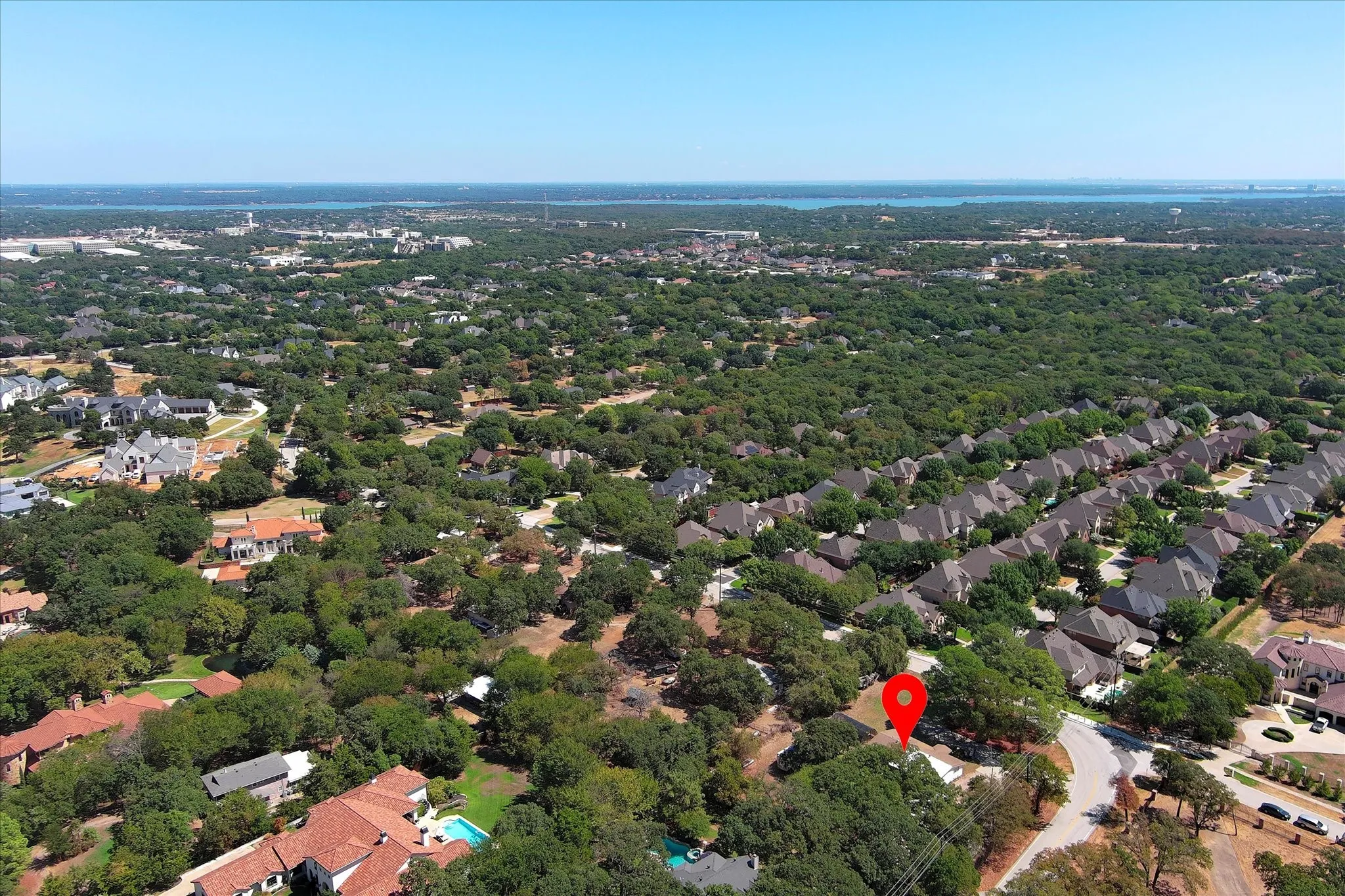 Red marks property location and shows lake in the distance and the varied upscale neighborhoods and estate homes nearby.