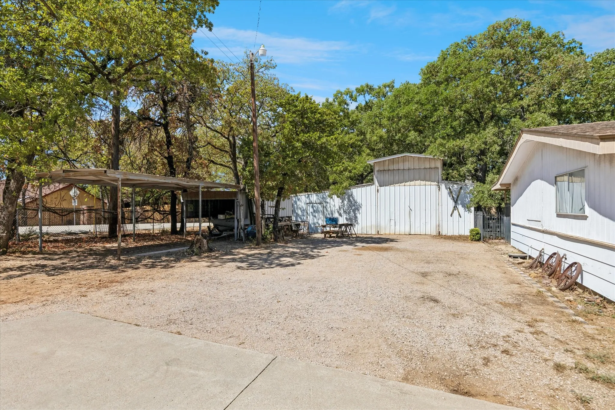 The property includes out buildings: a 1200-sf welding shop and two storage sheds, 400 sf and 600 sf respectively. All three convey As Is.