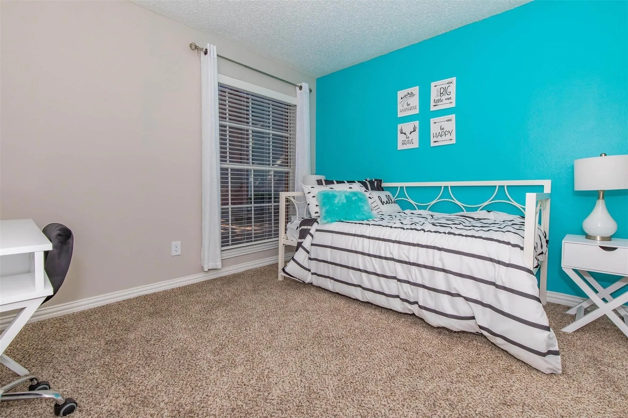 Wall-to-wall carpeting with a neutral tone, window with blinds, and a two-tone wall finish
