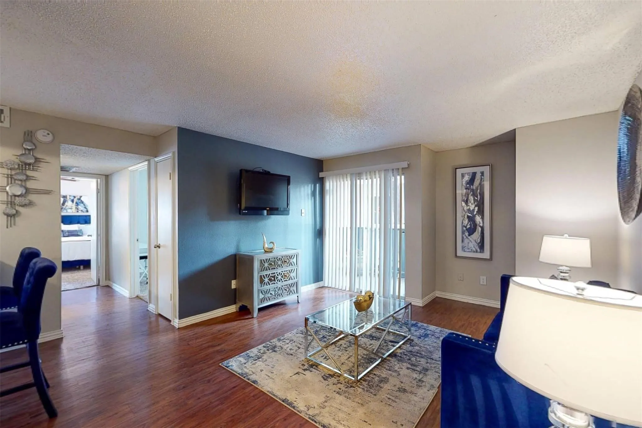 Wood-finish flooring throughout, complemented by light-toned wall finishes and a contrasting accent wall