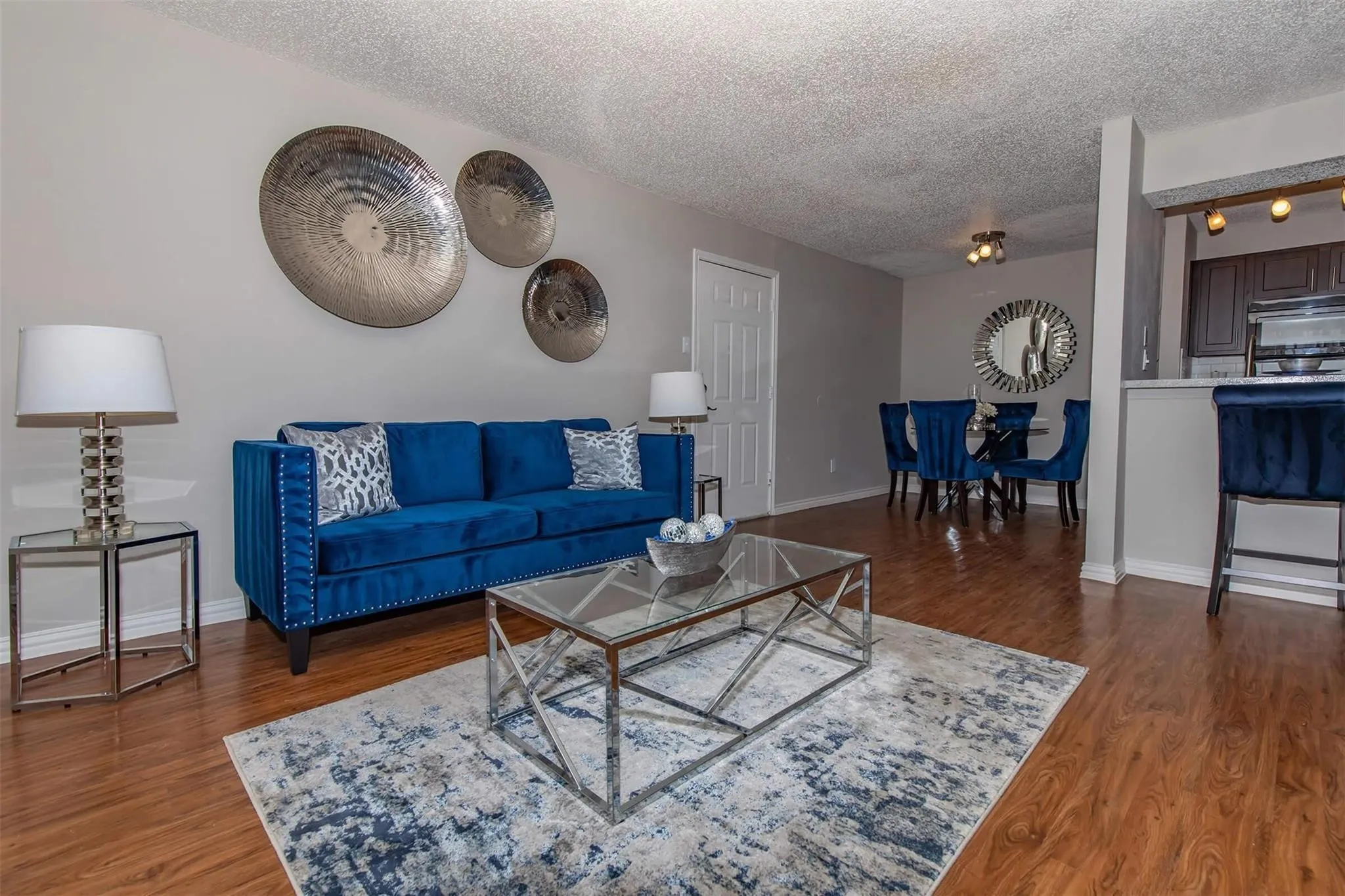 Wood-finish flooring throughout, with neutral wall tones and a textured ceiling