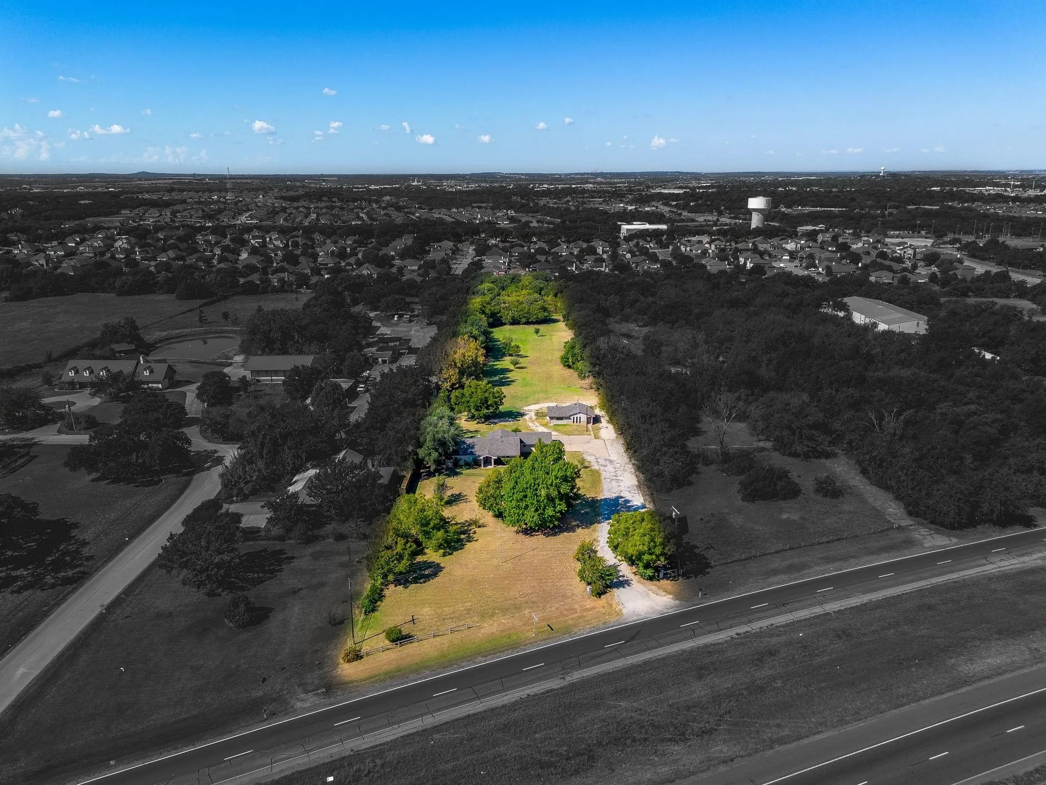 Expansive property with a single-story residence and mature trees