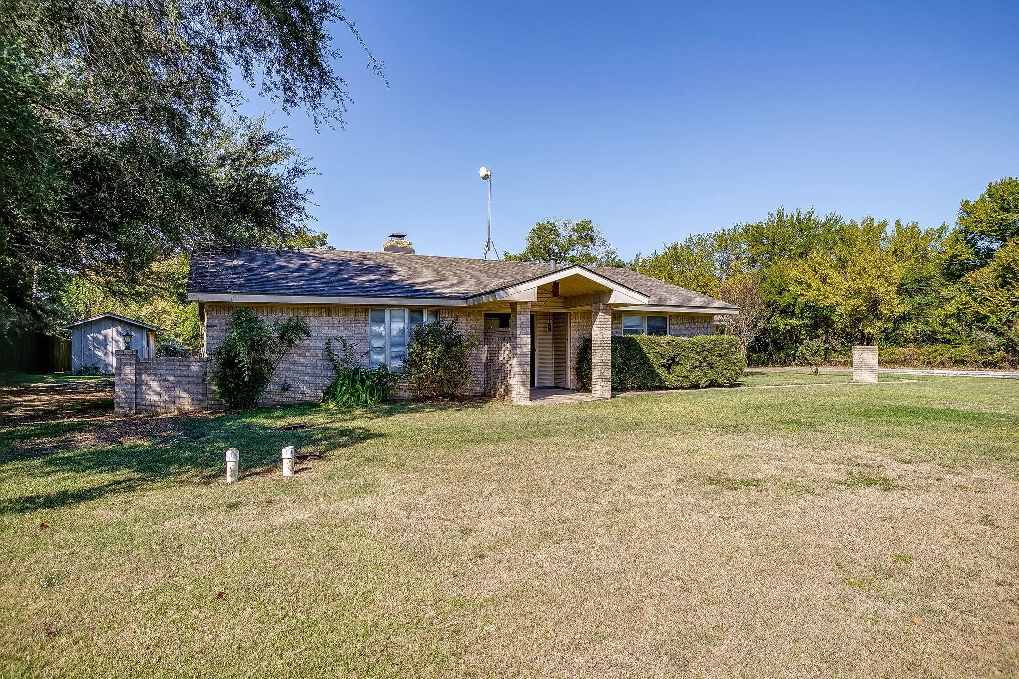 Single-story residence featuring a brick and stucco exterior, covered entry, and a side-gabled roof