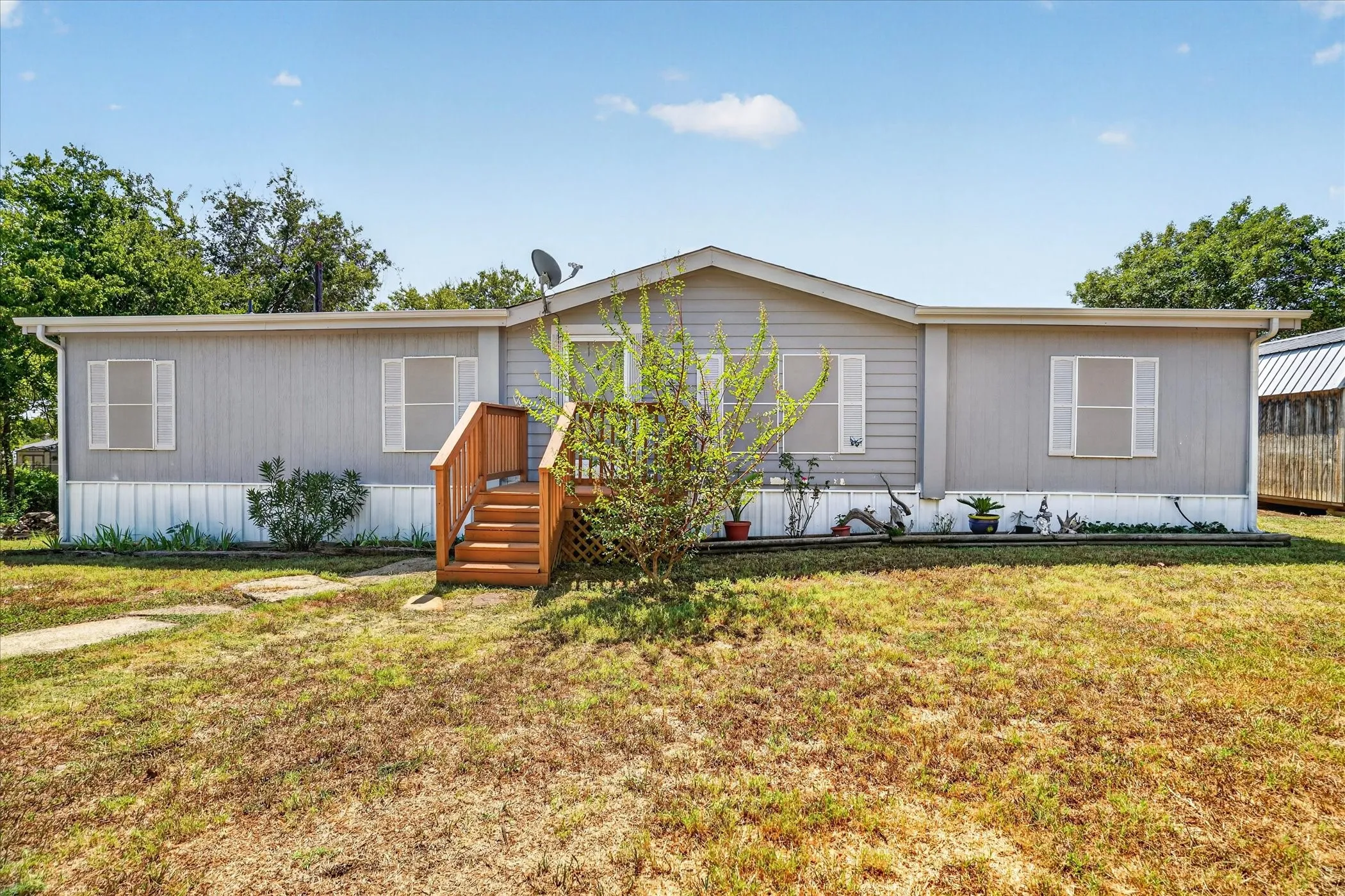 Single-story property with gray horizontal siding and white trim