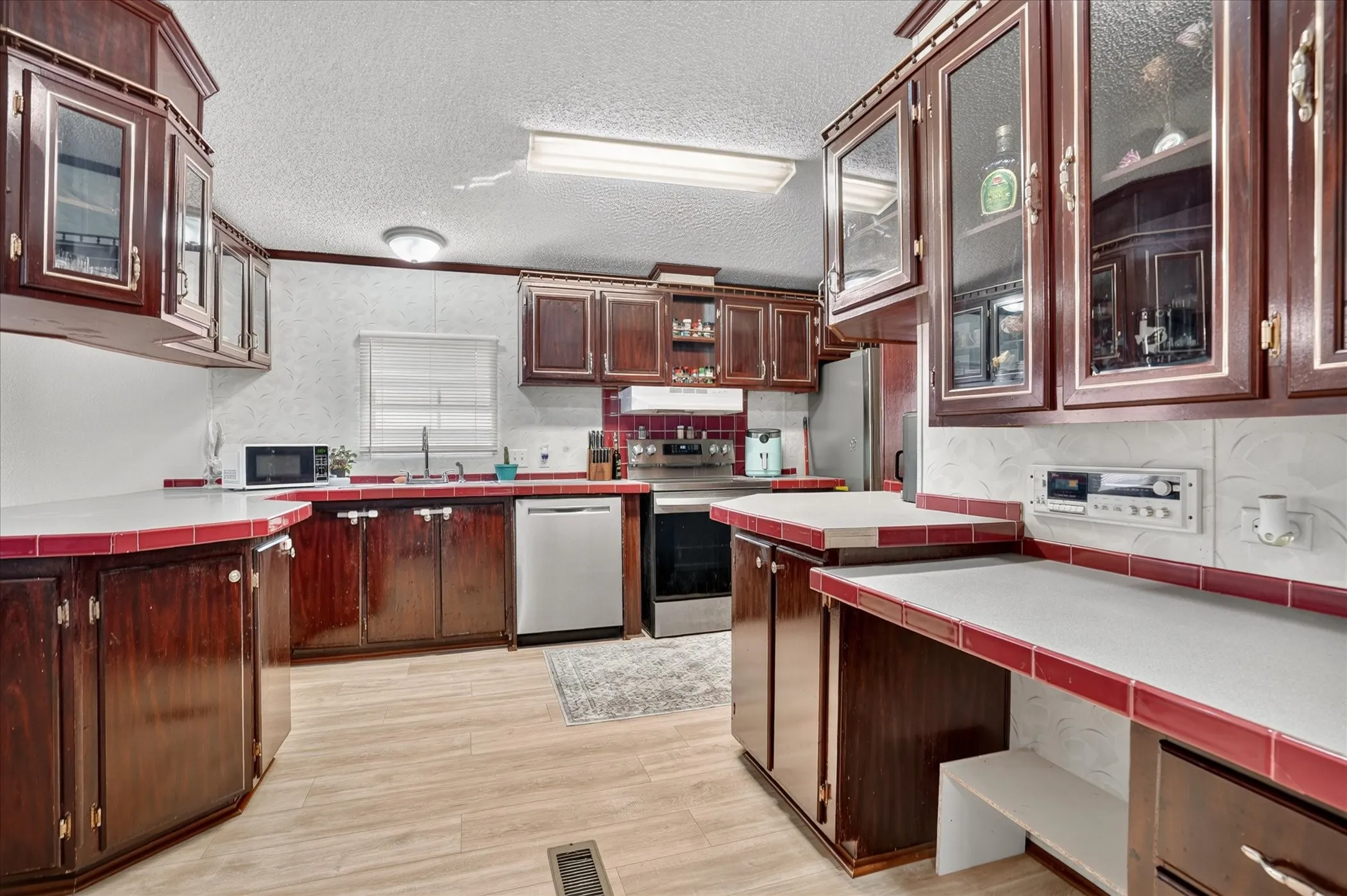 Kitchen with wood-finish flooring and solid wood cabinetry