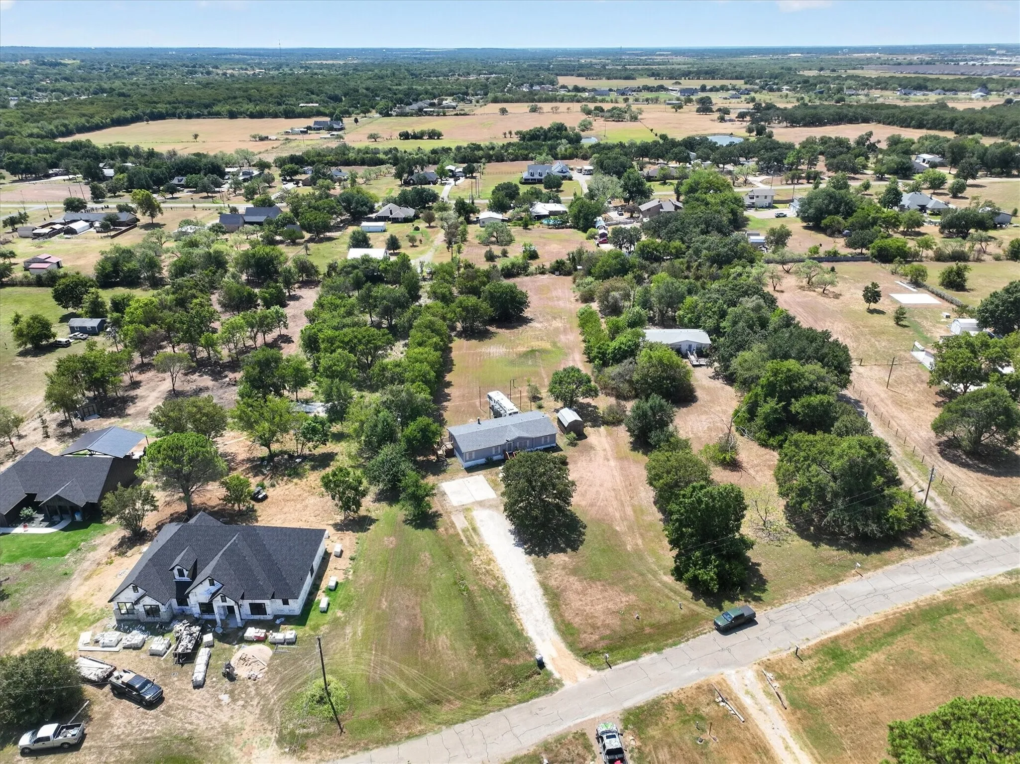 Expansive acreage featuring scattered mature trees and open clearings