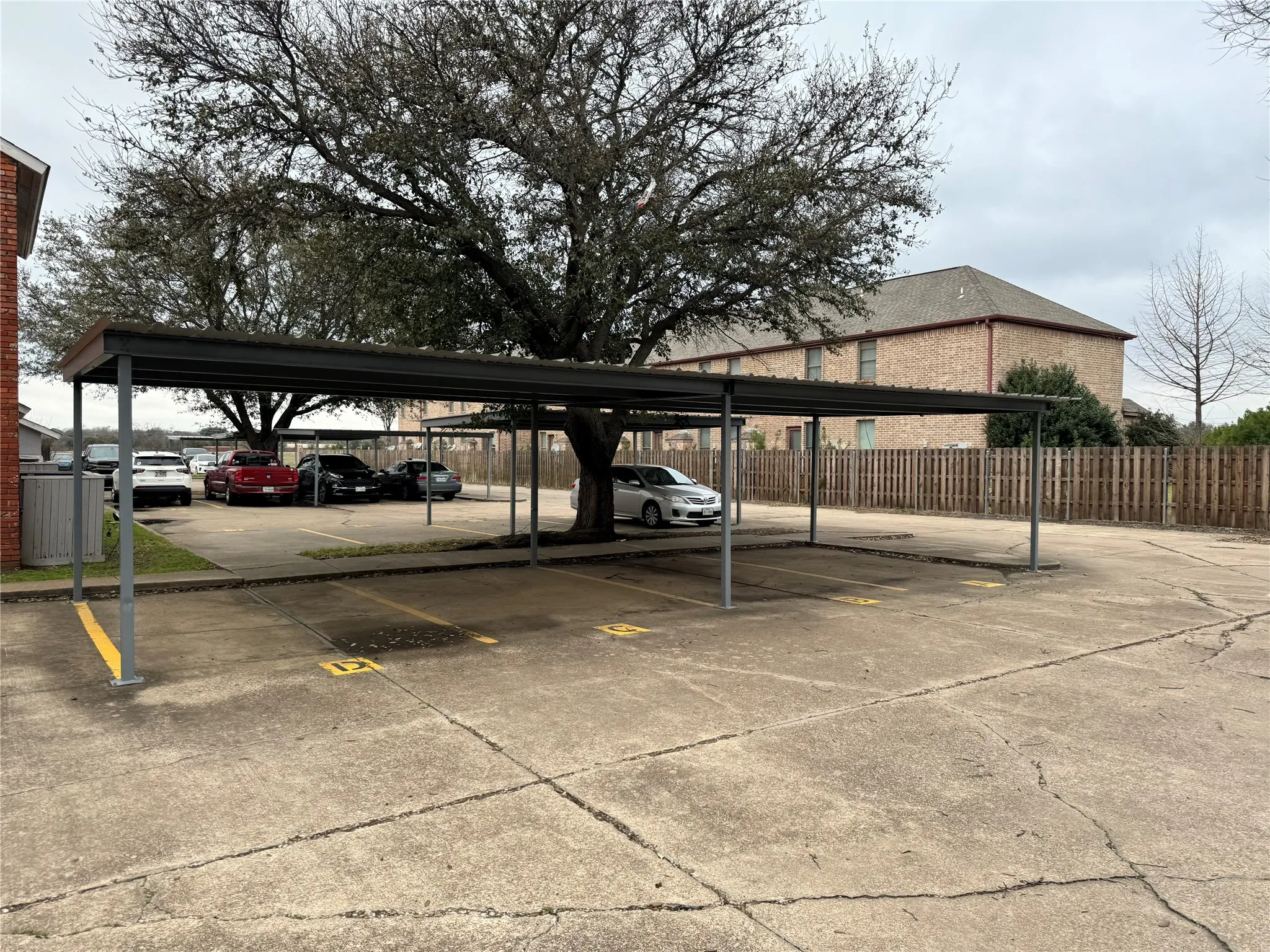 Covered parking lot with fence