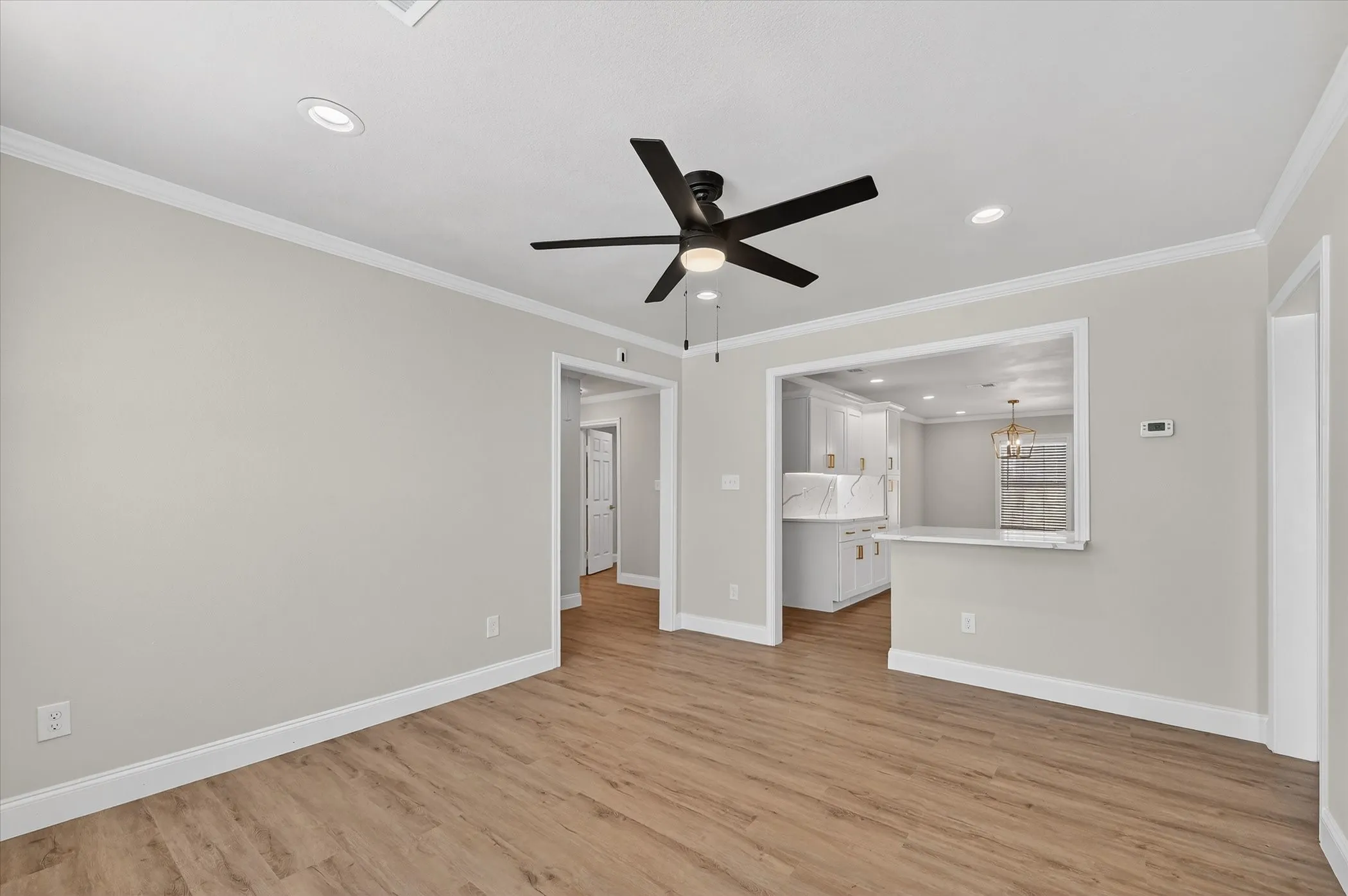 Wood-finish flooring, recessed lighting, and a modern ceiling fan