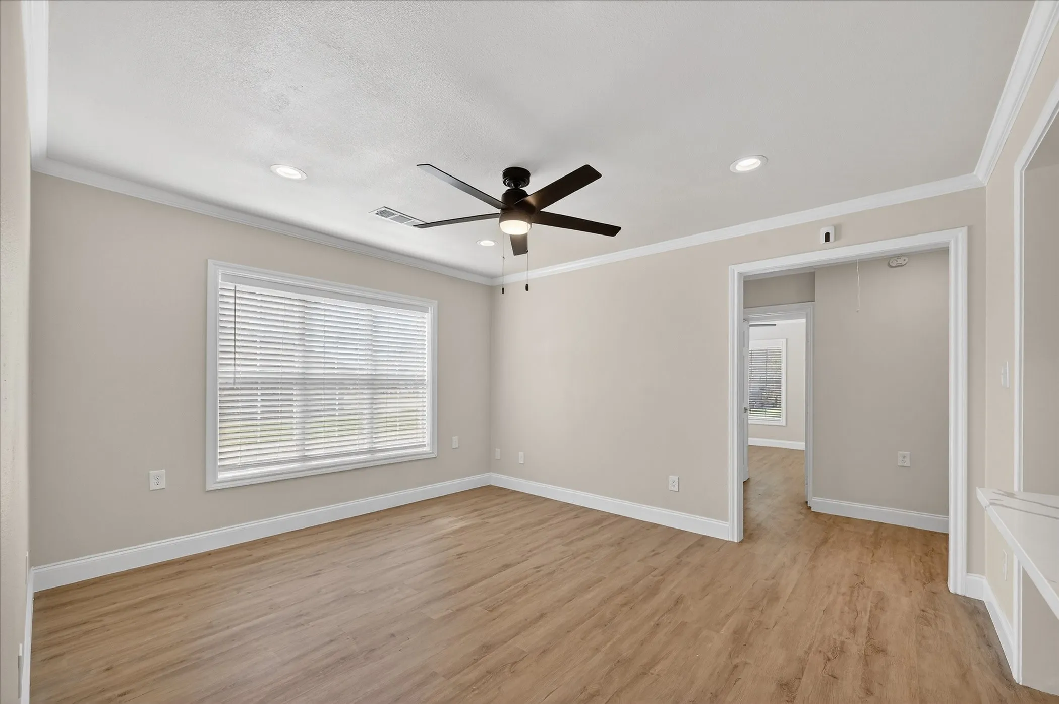 Wood-finish flooring, recessed lighting, and a ceiling fan