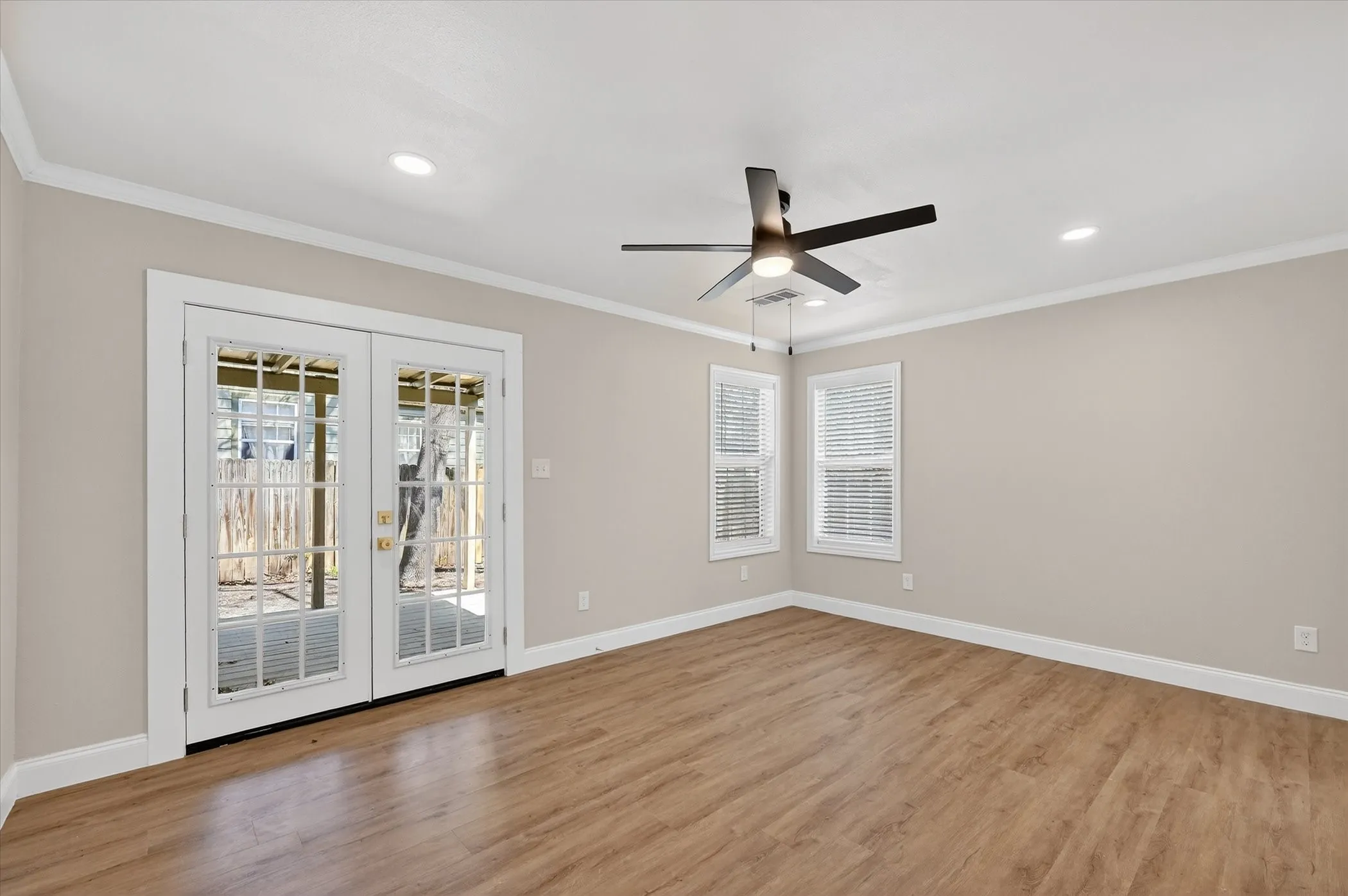 Wood-finish flooring, recessed lighting, and a contemporary ceiling fan