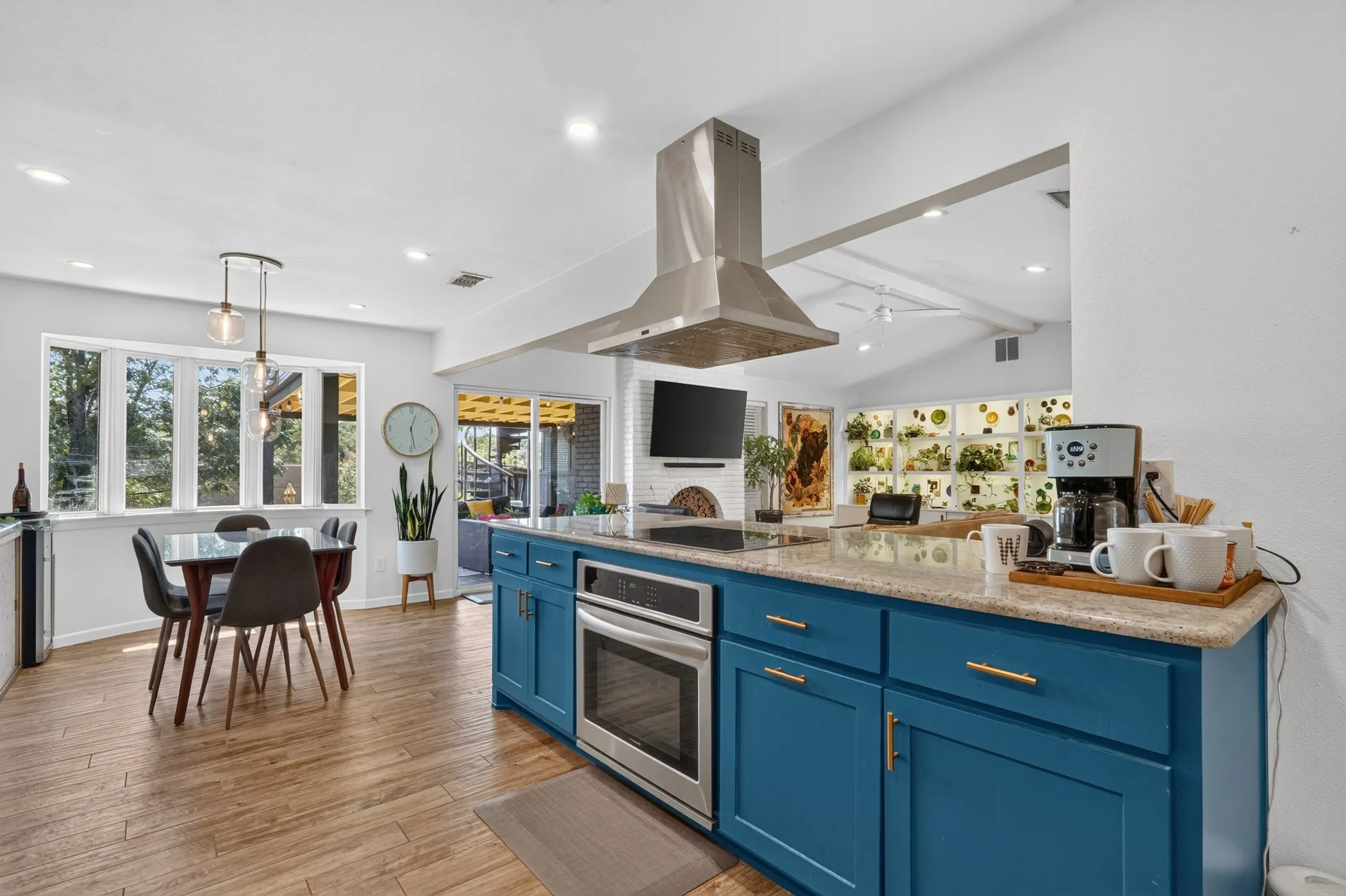 Kitchen island with blue cabinetry, gold-tone hardware, and a light-toned countertop