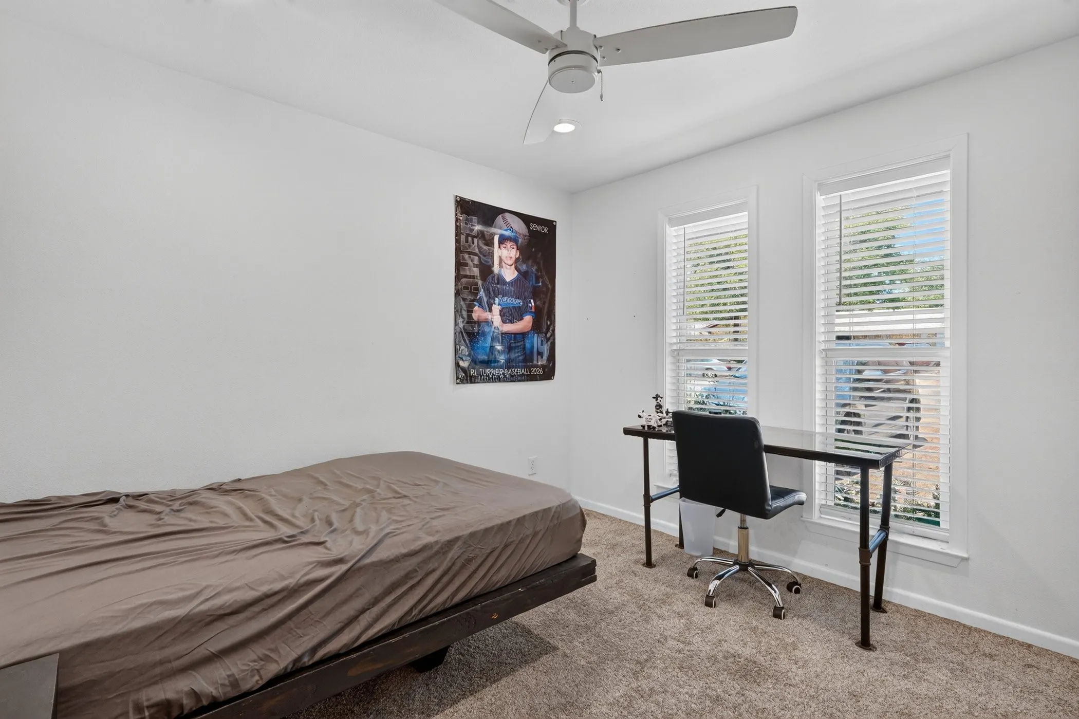 Neutral wall finishes, recessed lighting, ceiling fan with light, two windows with blinds, and carpeted flooring