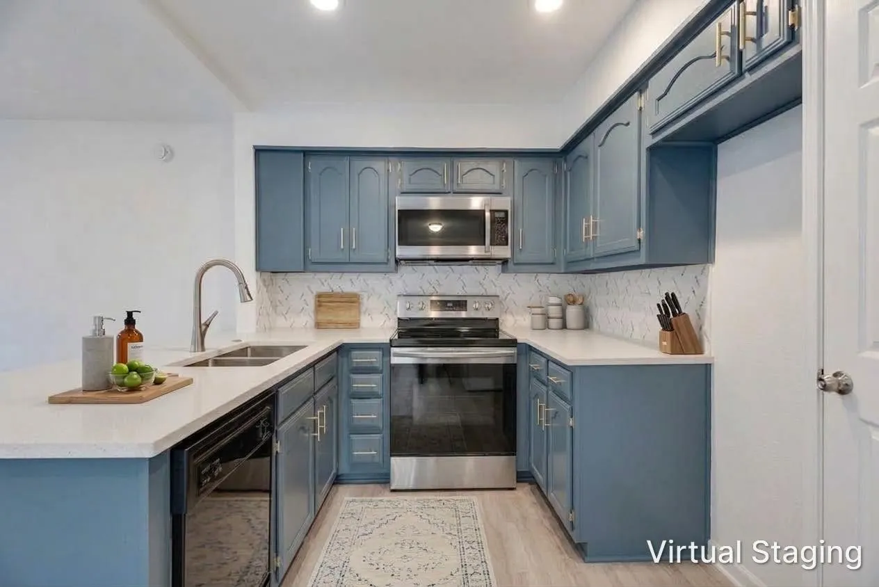 Kitchen featuring blue cabinetry, stainless steel appliances, white countertops, a double basin sink, and a patterned tile backsplash