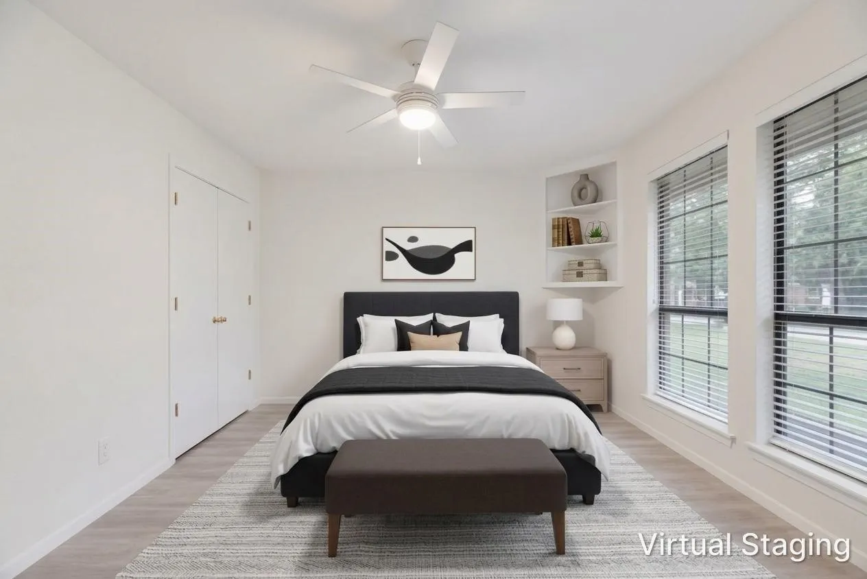Recessed built-in shelving, dual double-hung windows, wood-finish flooring, ceiling fan with light fixture, and two panel closet doors