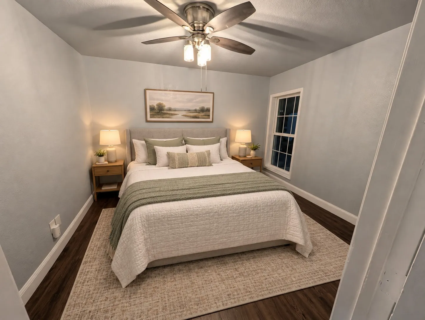 Wood-finish flooring, ceiling fan with integrated lighting, and a window with white trim