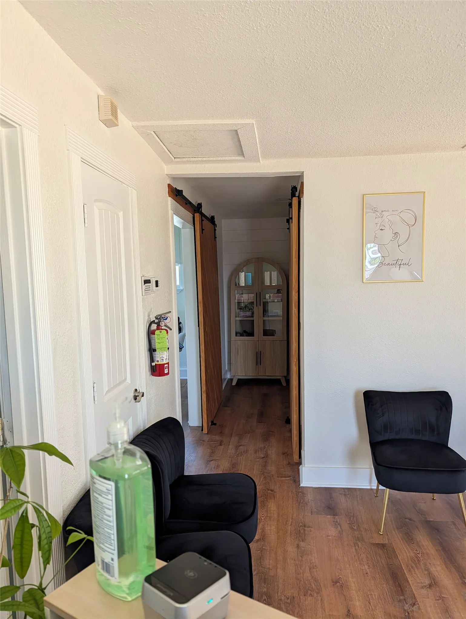 Hallway that separates the two office spaces.  Each office has sliding barn doors for privacy