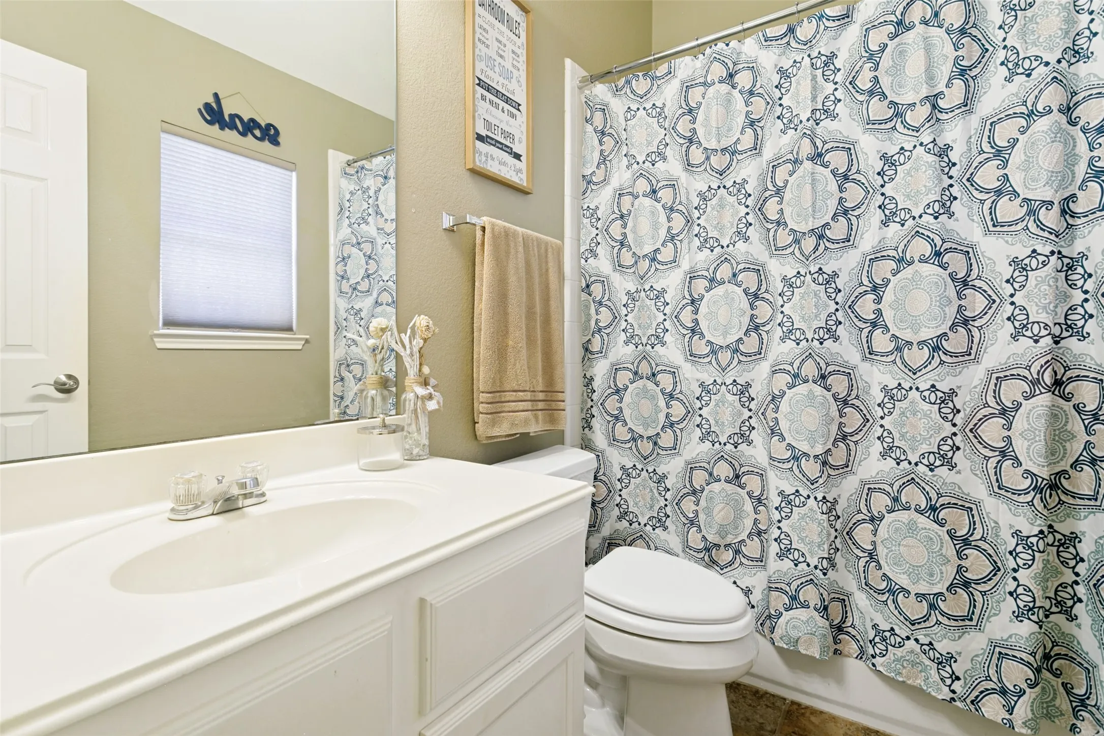 Built-in vanity with integrated sink, chrome faucet, and storage cabinetry