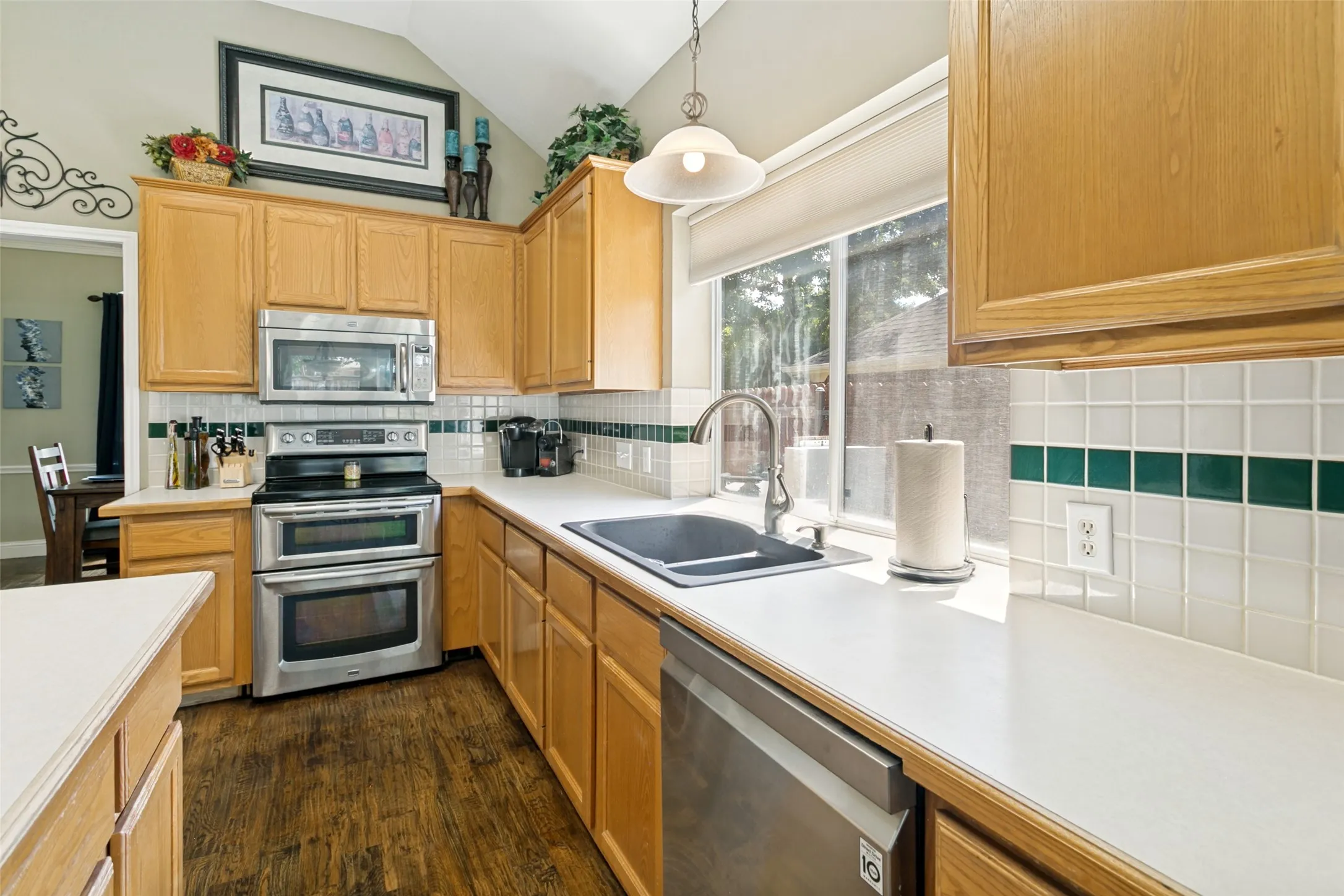 Natural lighting enhance the abundant counter space and a tile backsplash