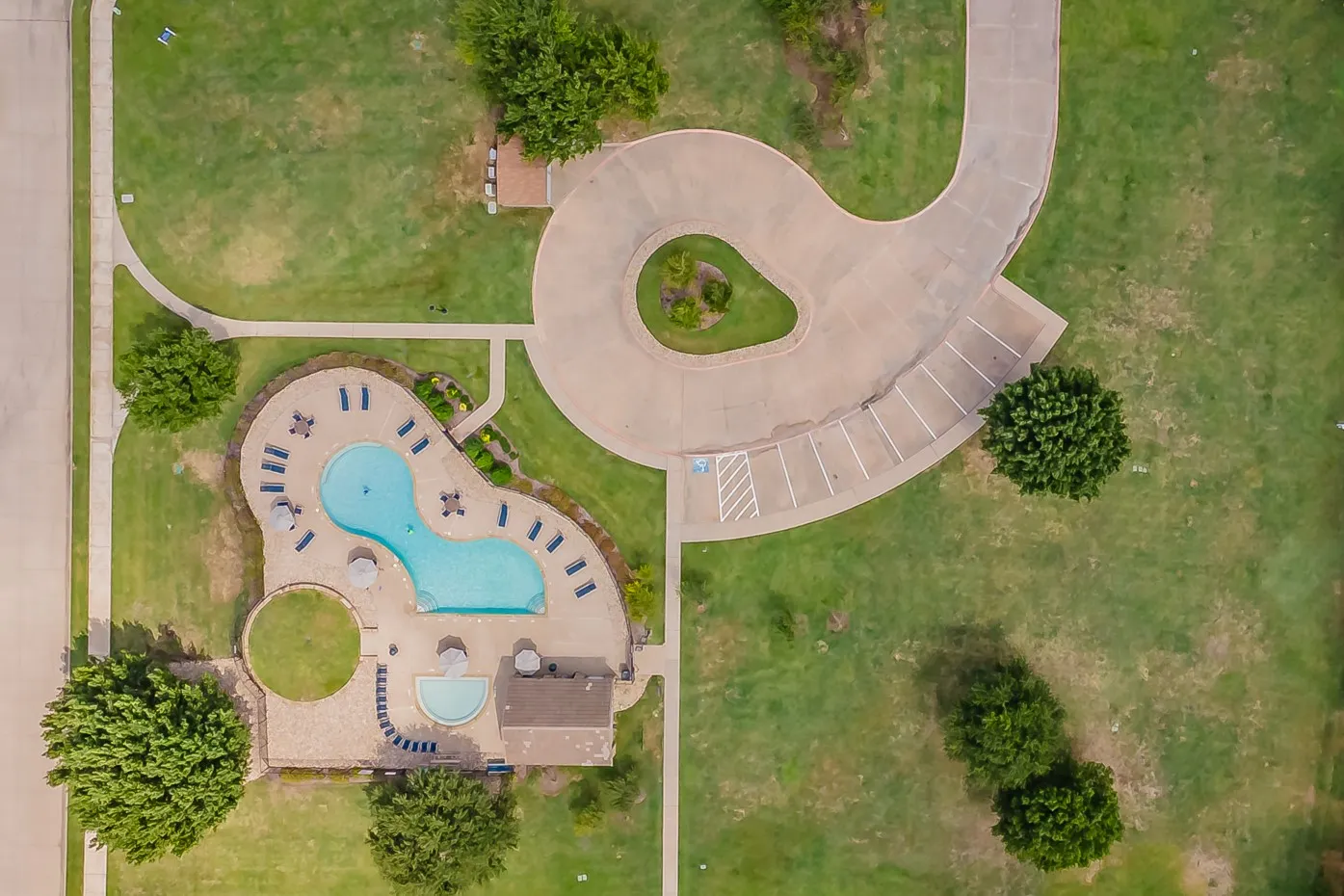 Resort-style pool with integrated spa and extensive stone decking