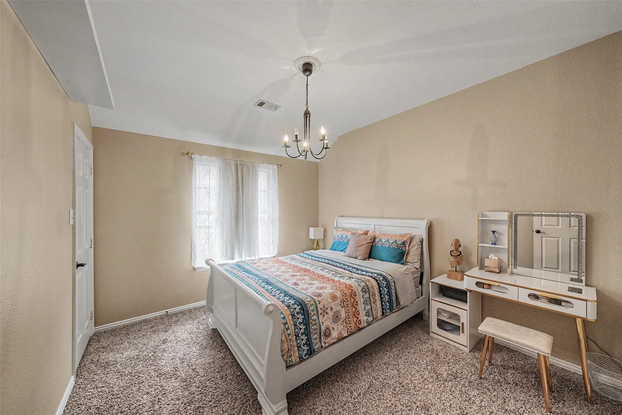 Plush carpeting, neutral wall tones, and a multi-pane window