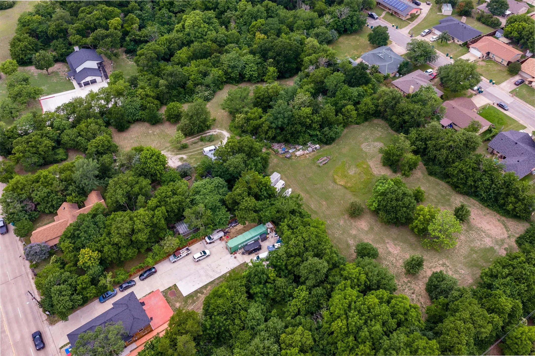 Extensive land area featuring mature trees and open grassy spaces