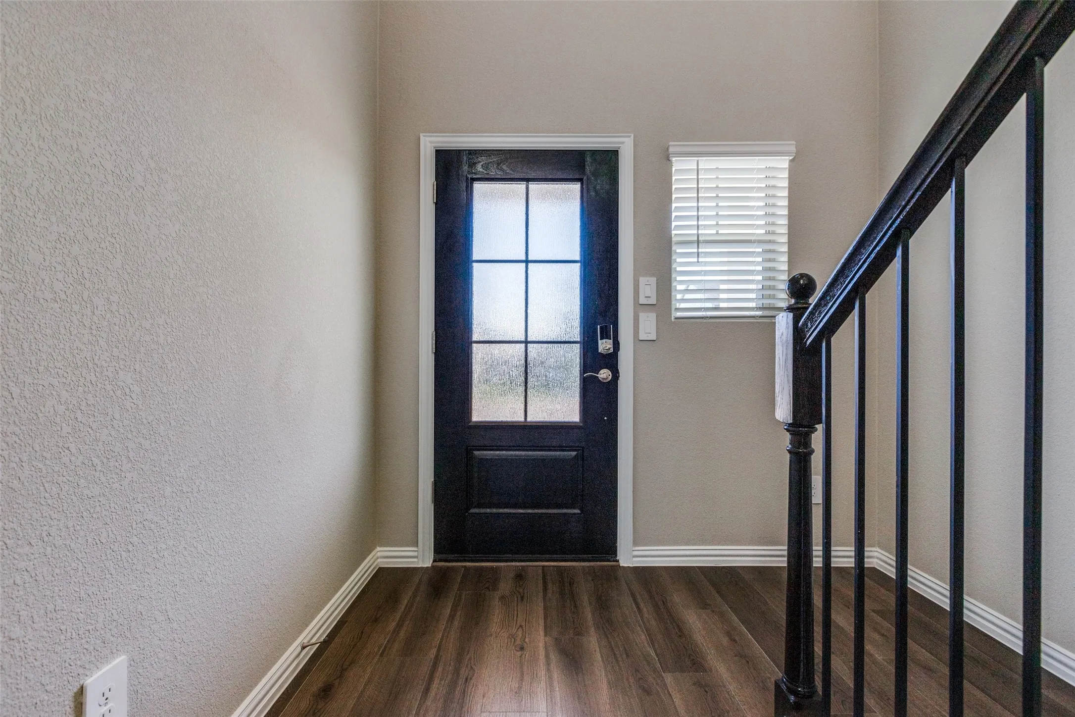 Foyer entrance featuring dark hardwood / wood-style floors