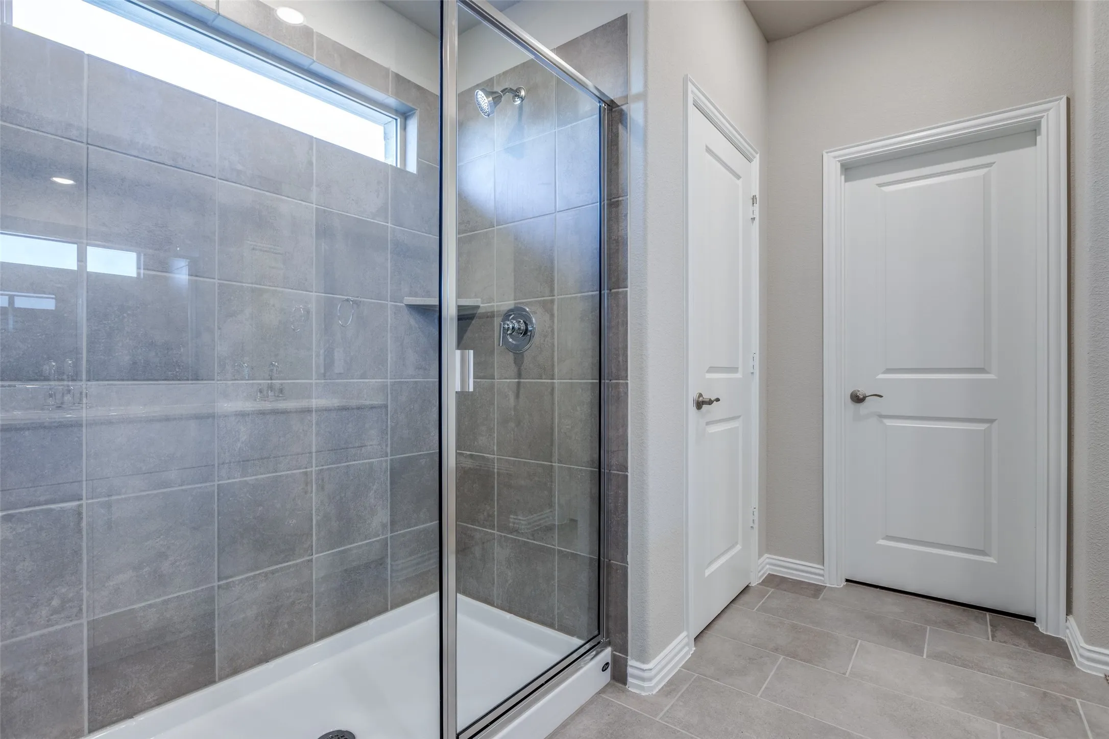 Bathroom featuring tile patterned flooring and an enclosed shower
